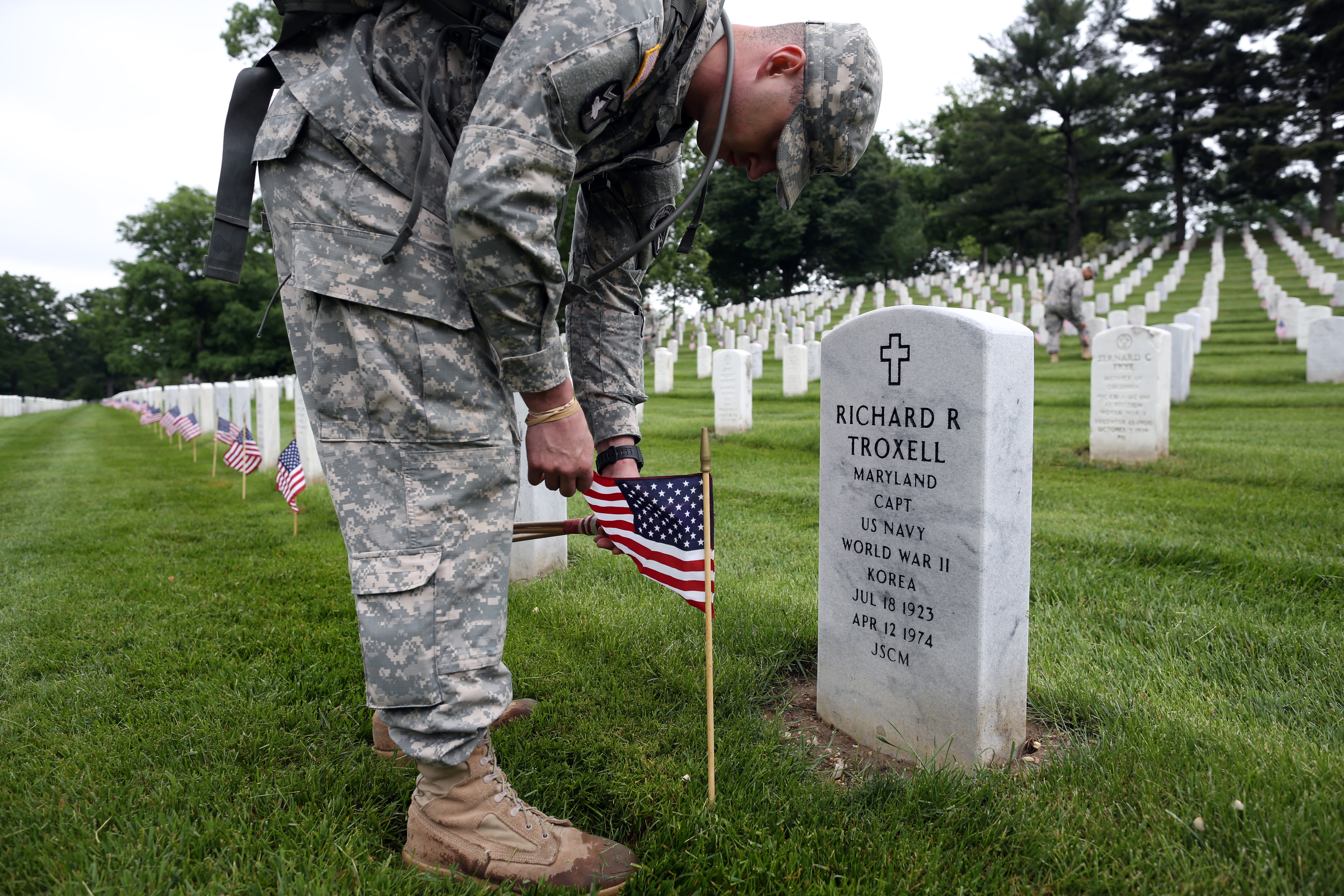 Over 1,000 members of the U.S. Infantry Regiment (The Old Guard) place 228,000 flags at headstones for Memorial Day weekend at Arlington National Cemetery in Arlington, Va. on on May 21, 2015.