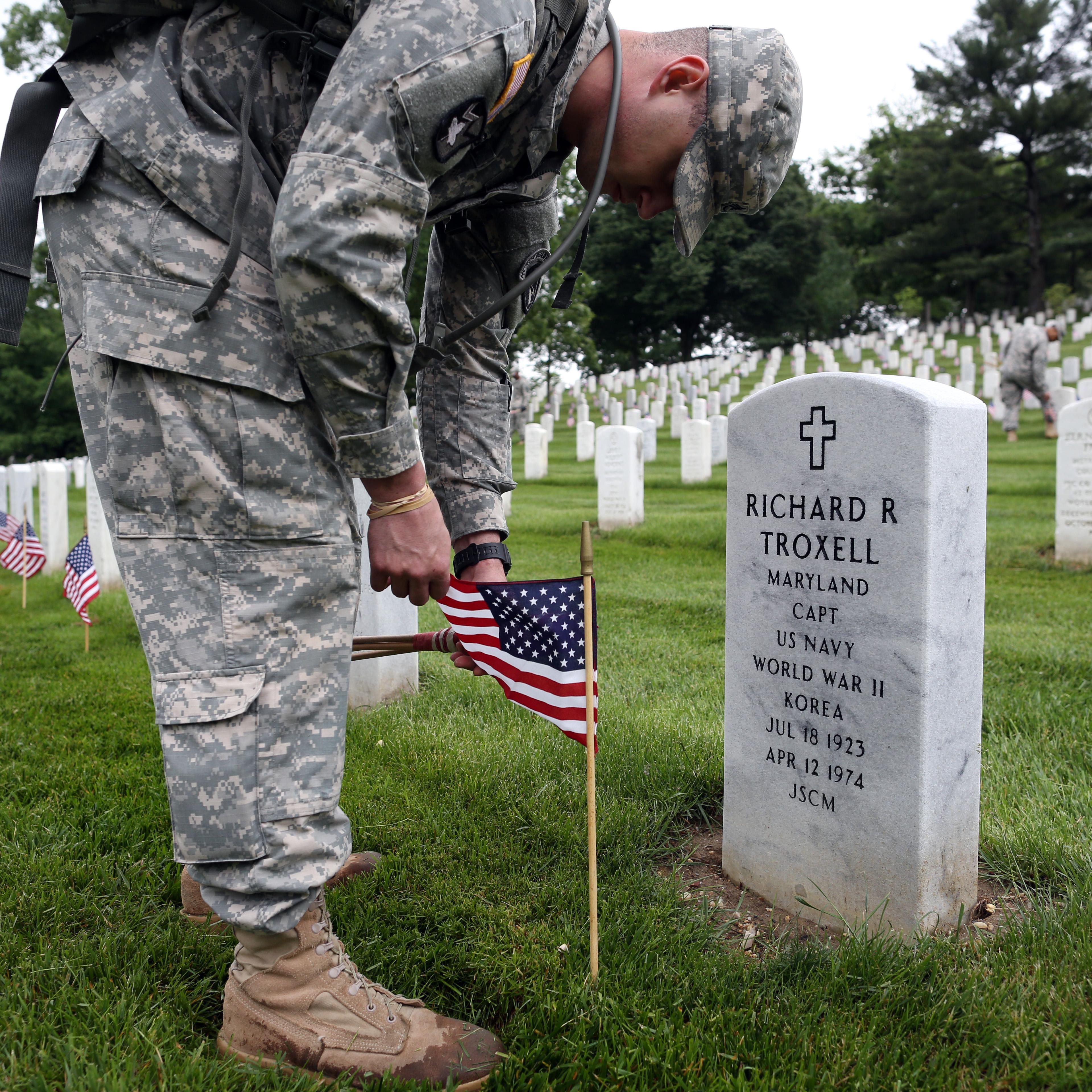 Over 1,000 members of the U.S. Infantry Regiment (The Old Guard) place 228,000 flags at headstones for Memorial Day weekend at Arlington National Cemetery in Arlington, Va. on on May 21, 2015.