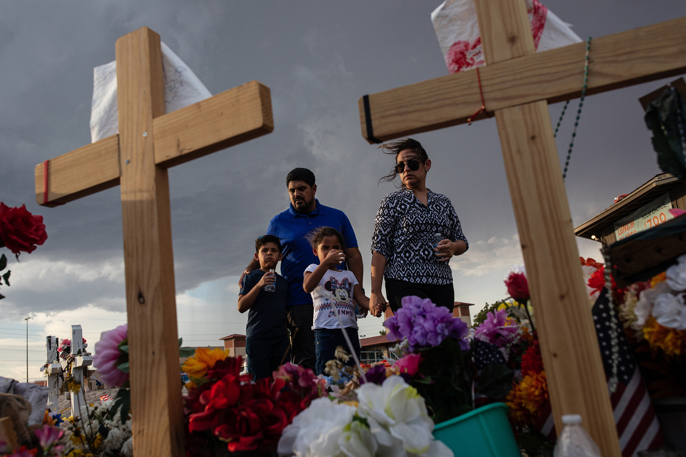 The Valenzuela family visits a makeshift memorial for victims of the shooting that killed 22 people at a Walmart store, in El Paso, Texas, Aug. 27, 2019. (Tamir Kalifa/The New York Times)