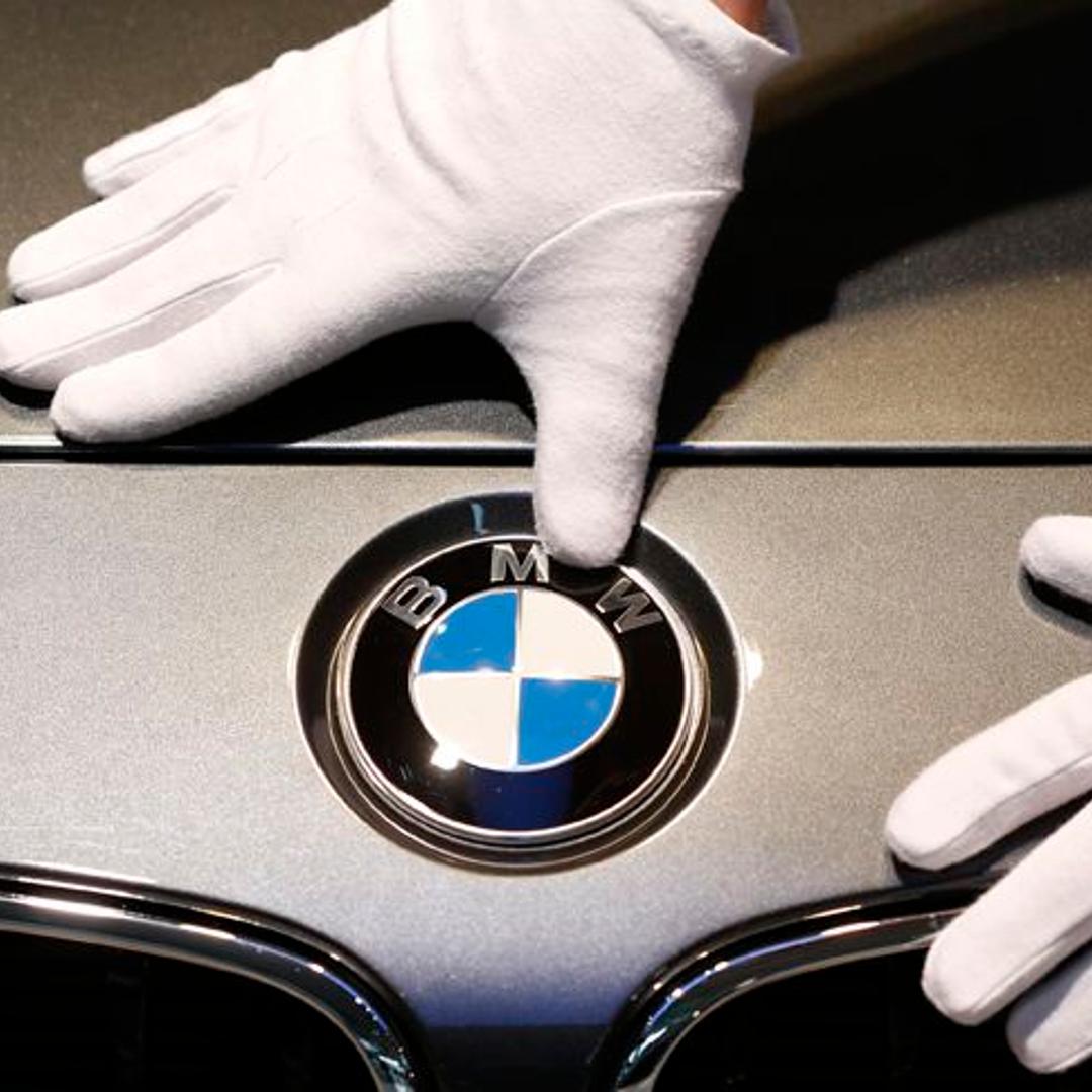 Man cleans BMW logo before news conference of German premium automaker BMW in Munich
