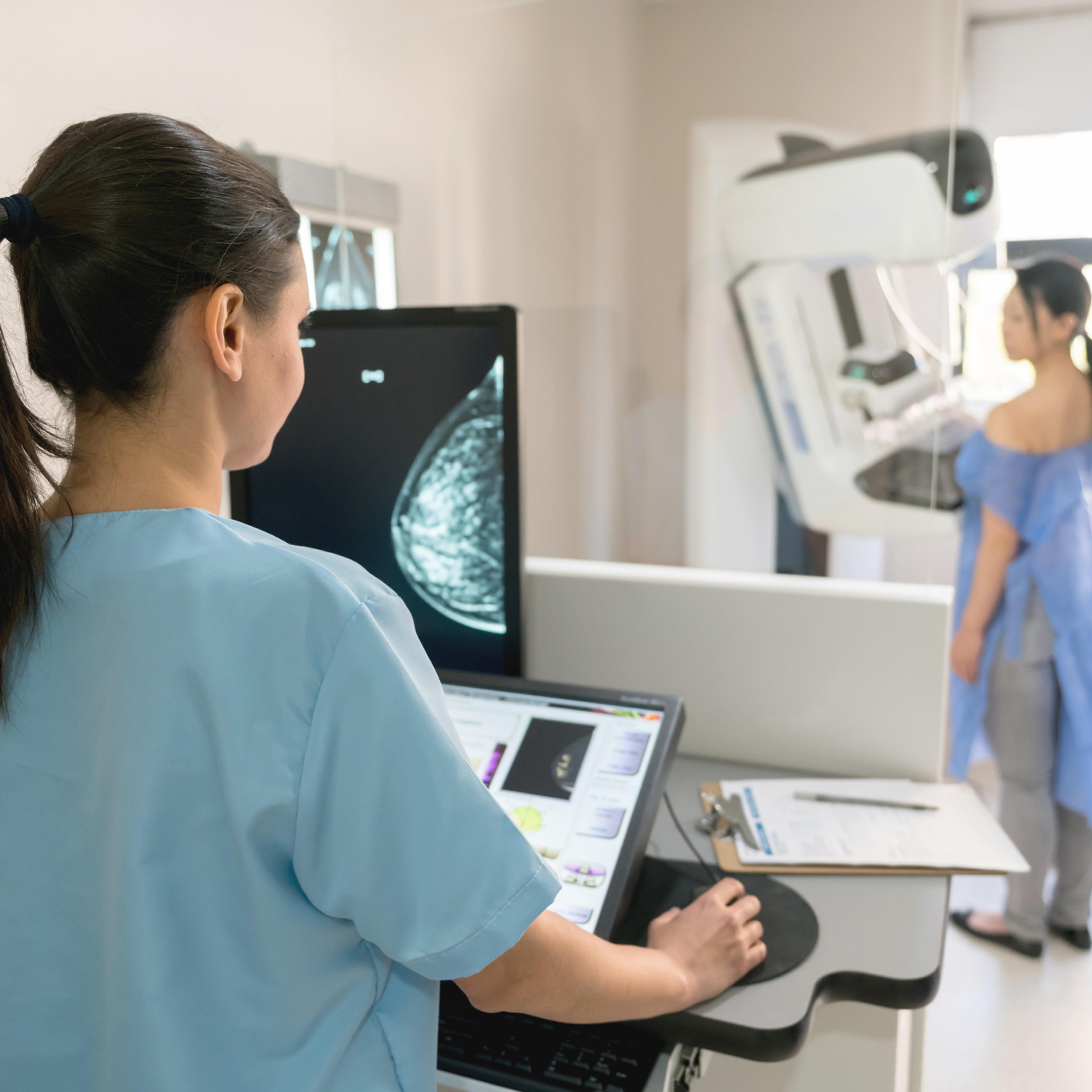 Unrecognizable nurse taking a mammogram exam to an adult patient