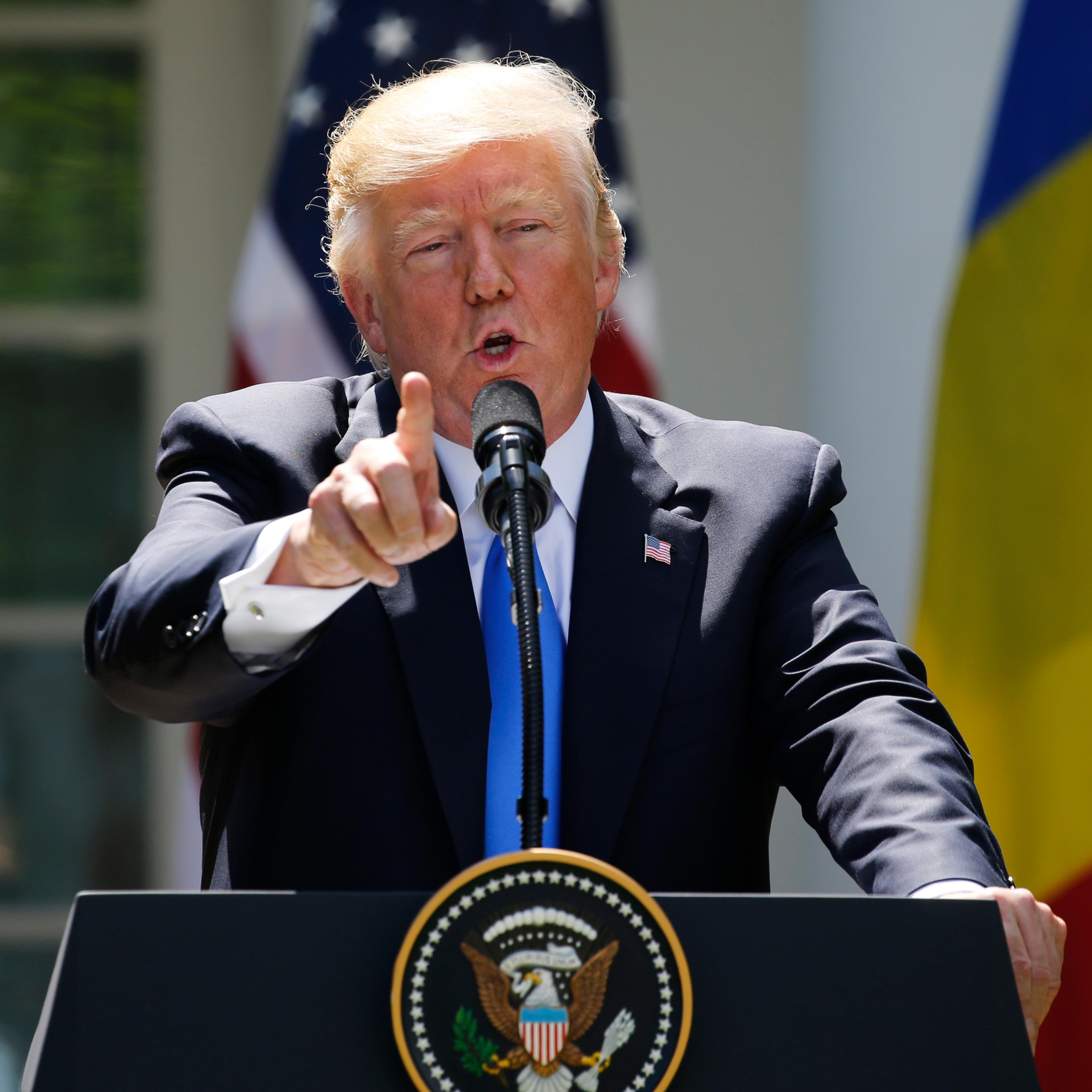 Trump reacts to a reporter's question during a joint news conference with Romanian Iohannis in the Rose Garden at the White House in Washington