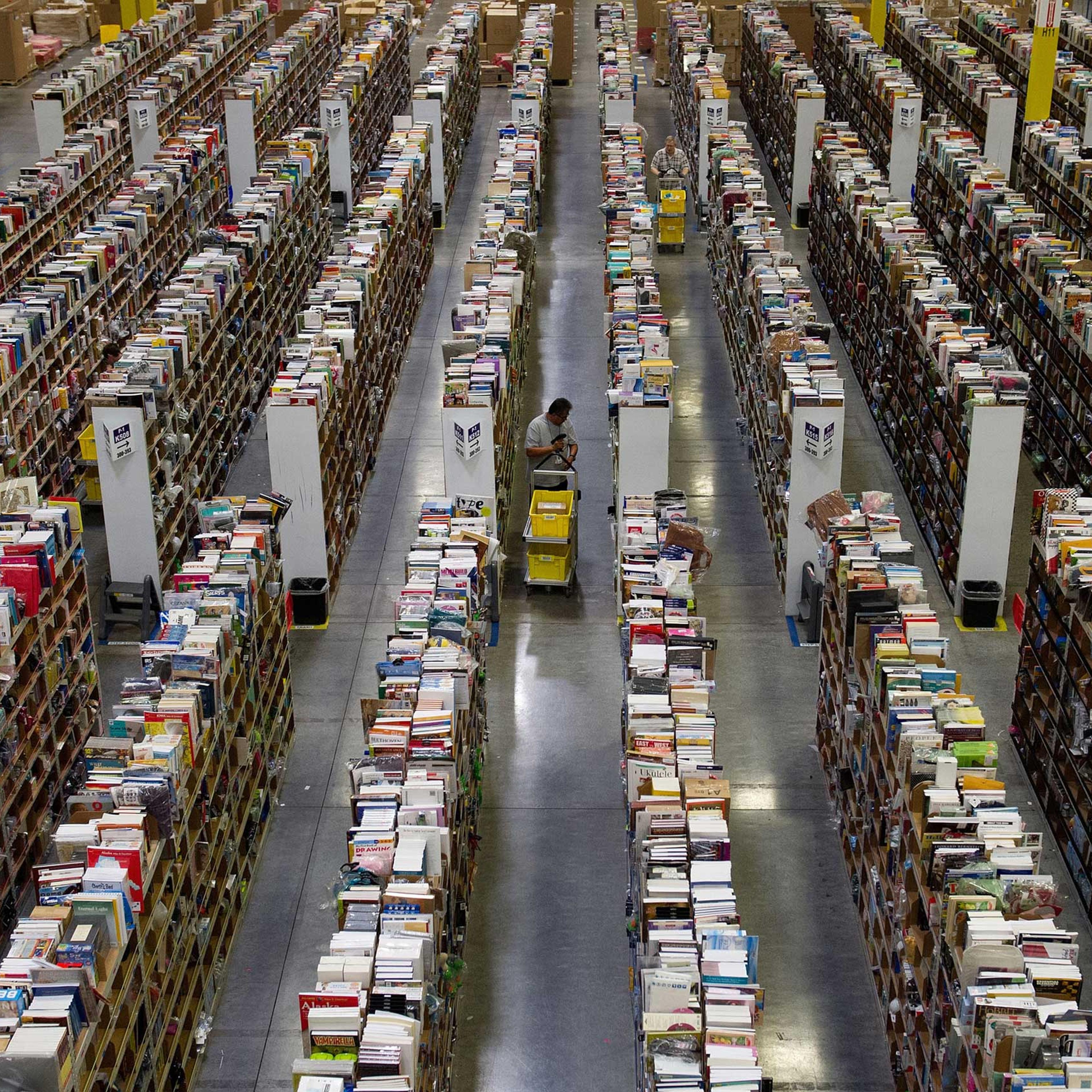 Employees collect merchandise ordered by customers for shipment from the Amazon.com distribution center in Phoenix, Arizona, Nov. 26, 2012.