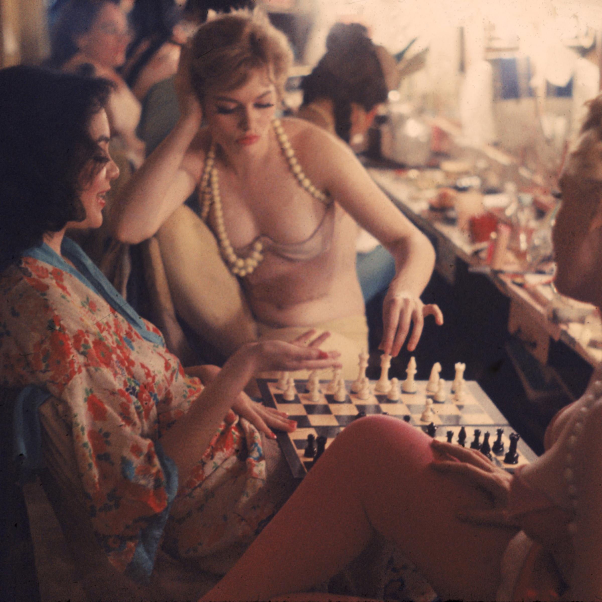 Between scenes in the show at New York's Latin Quarter, Pat Farrell prepares to make a chess move. Opponent (right) is Grace Sundstrom. Kibitzing at left is Shirley Forrest, an ex-schoolteacher.