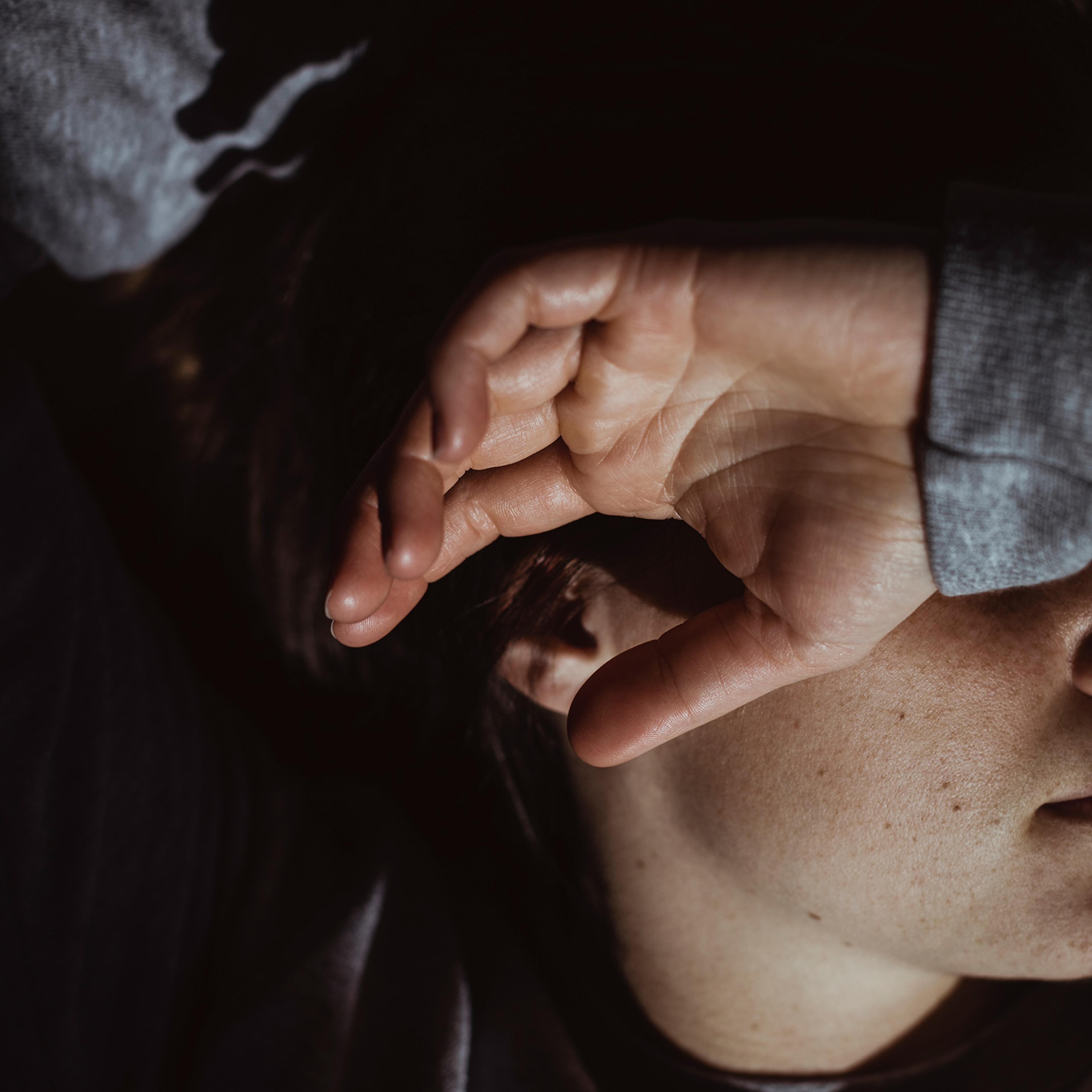 Close-up of stressed woman at home