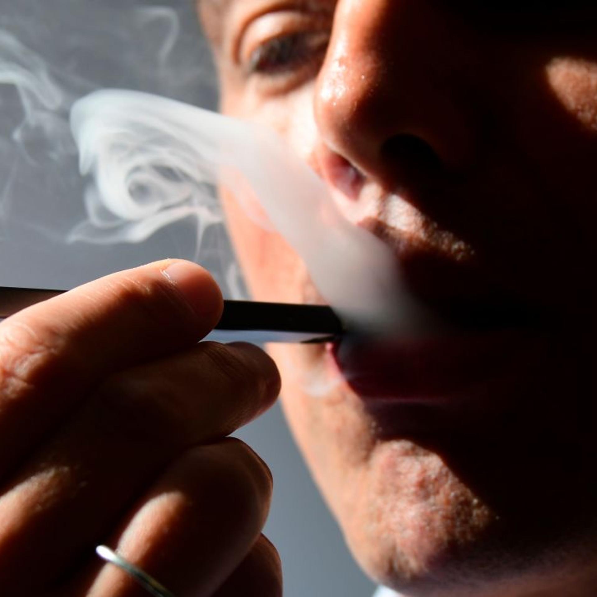 A man uses an e-cigarette