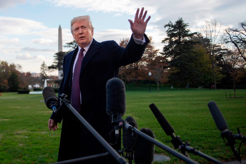 US President Donald Trump waves after speaking to the press