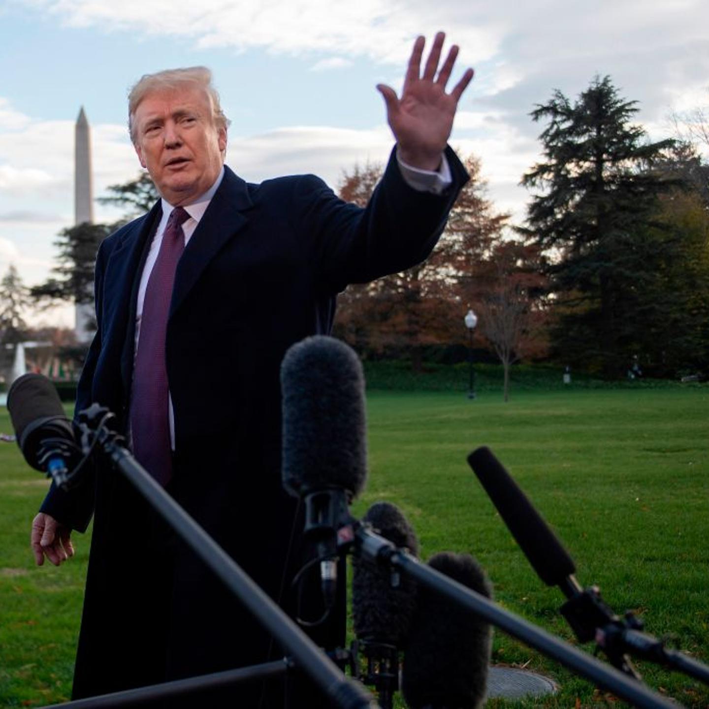 US President Donald Trump waves after speaking to the press