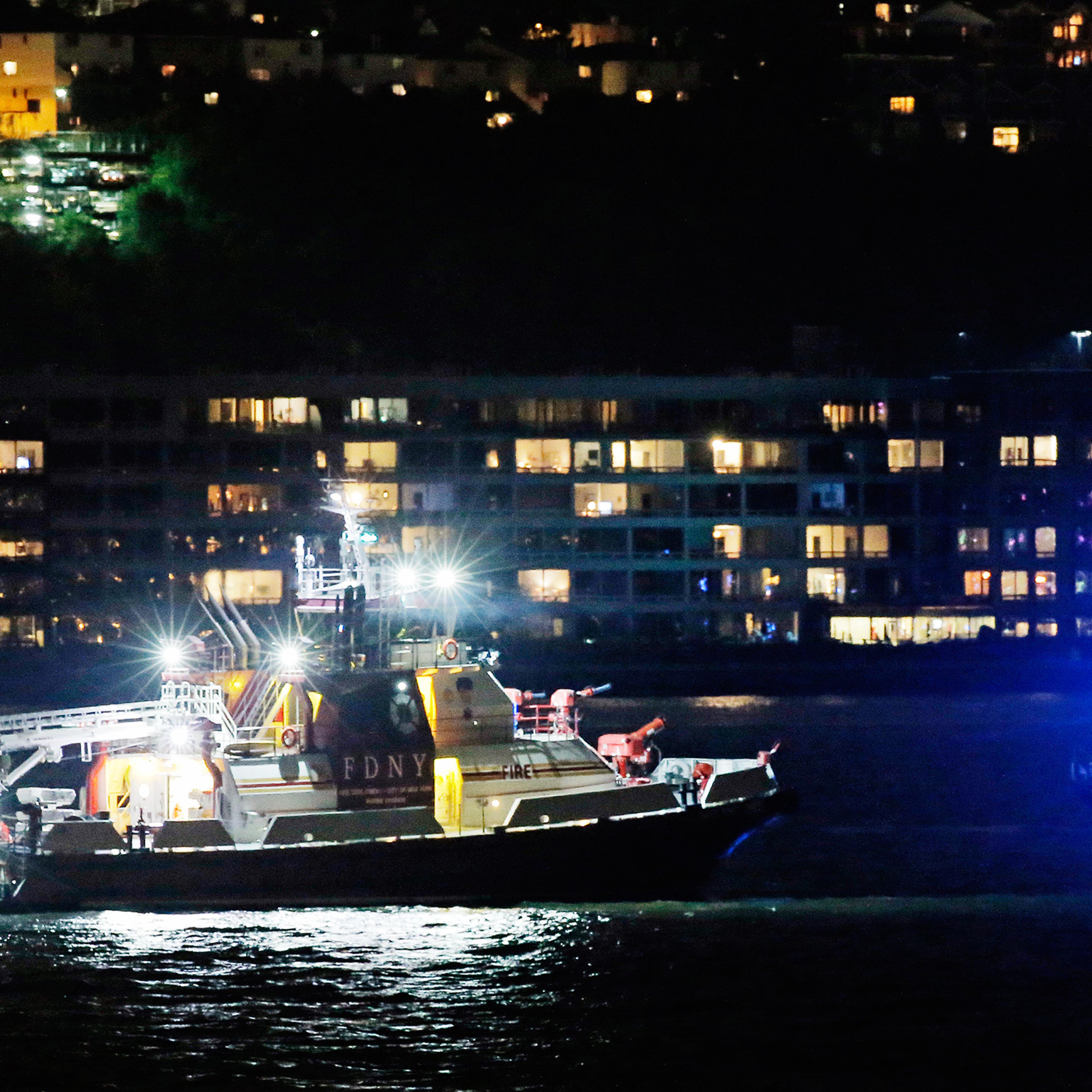An FDNY fire department boat searches the Hudson River for the wreckage of a vintage P-47 Thunderbolt airplane that crashed in the river in New York City, May 27, 2016.
