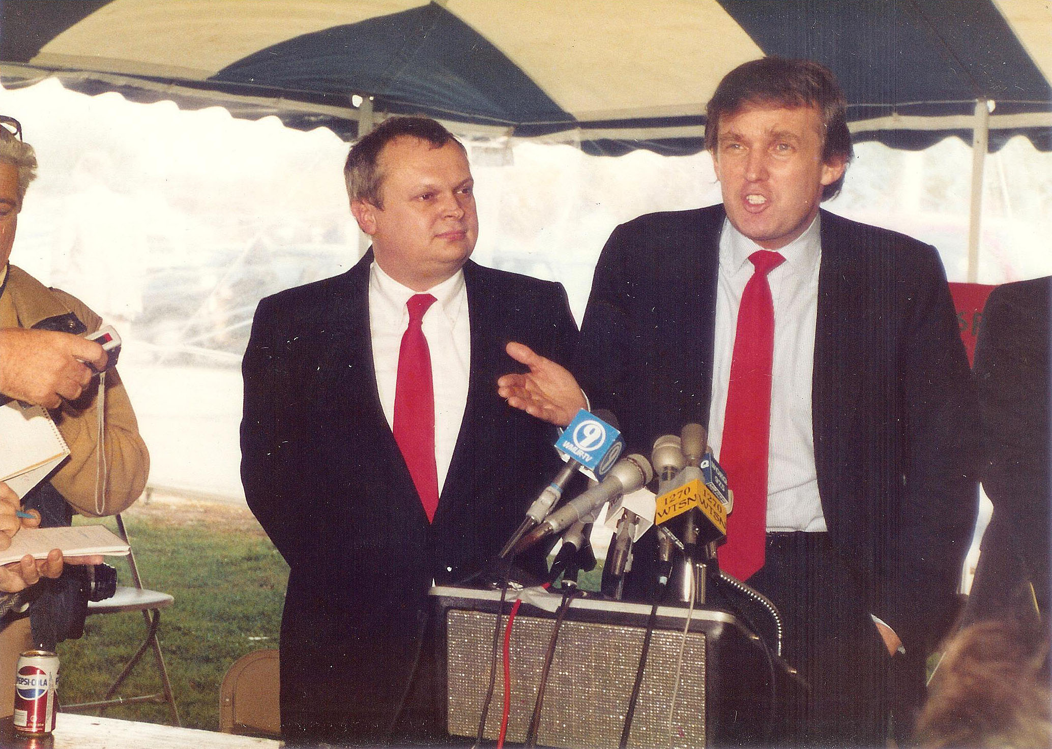 Donald Trump (right) stands beside Mike Dunbar as he speaks at a press conference in Portsmouth, N.H., on Oct. 22, 1987. 