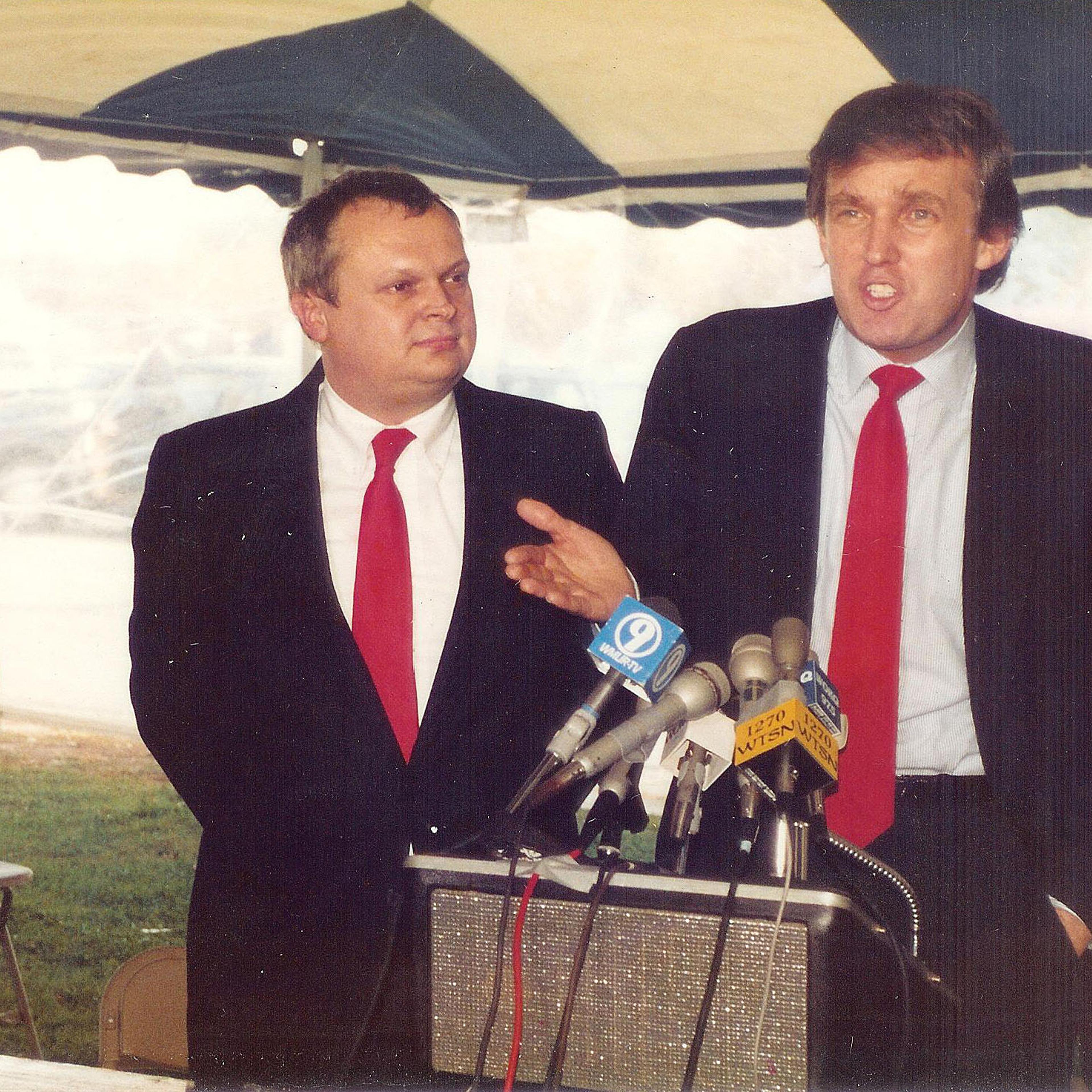Donald Trump (right) stands beside Mike Dunbar as he speaks at a press conference in Portsmouth, N.H., on Oct. 22, 1987.