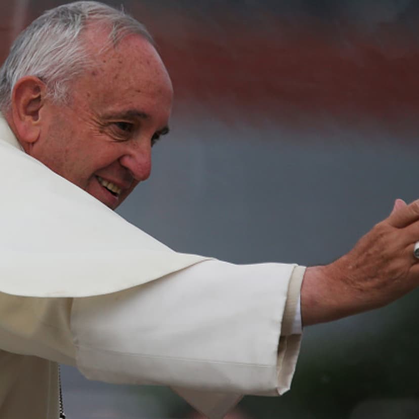 Pope Francis waves to the crowd from the Popemobile while making his way to celebrate an open-air Mass on July 9, 2015 in Santa Cruz, Bolivia.