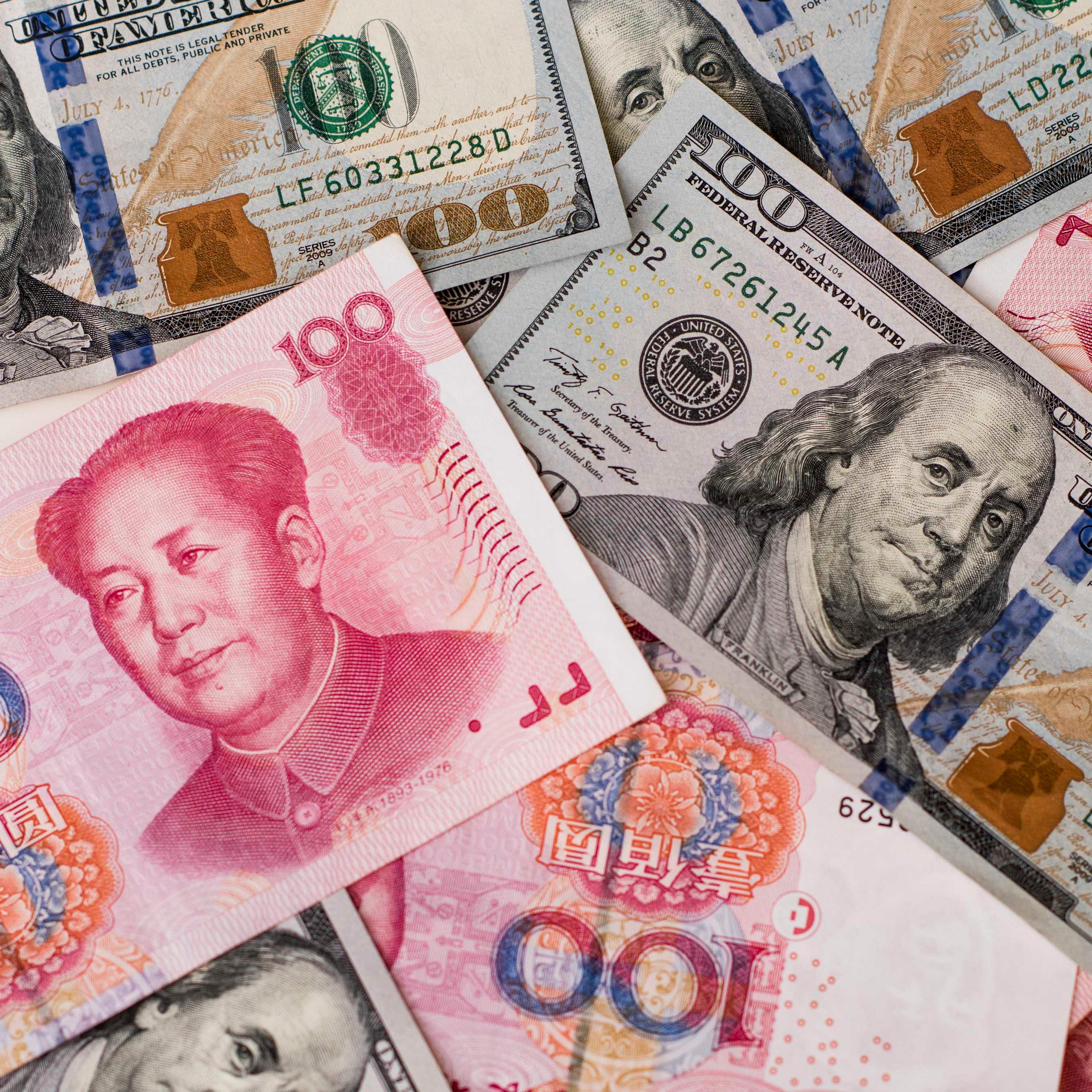 Yuan And Dollar Banknotes Ahead Of Tenth Anniversary Of China's Yuan Reform