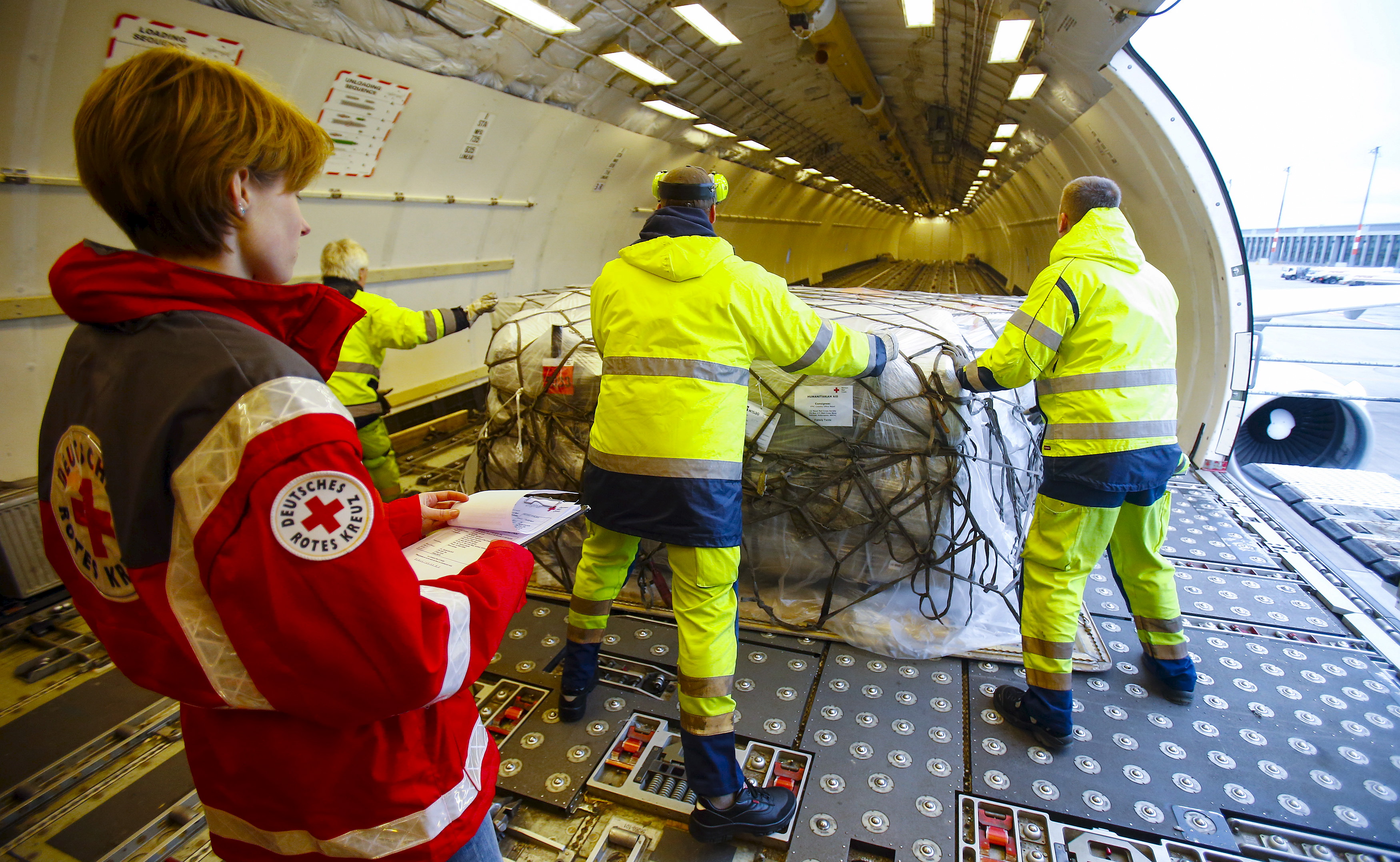 Workers load humanitarian aid from German Red Cross (DRK) for victims of the earthquake in Nepal, into an aircraft at Schoenefeld airport outside Berlin April 27, 2015.