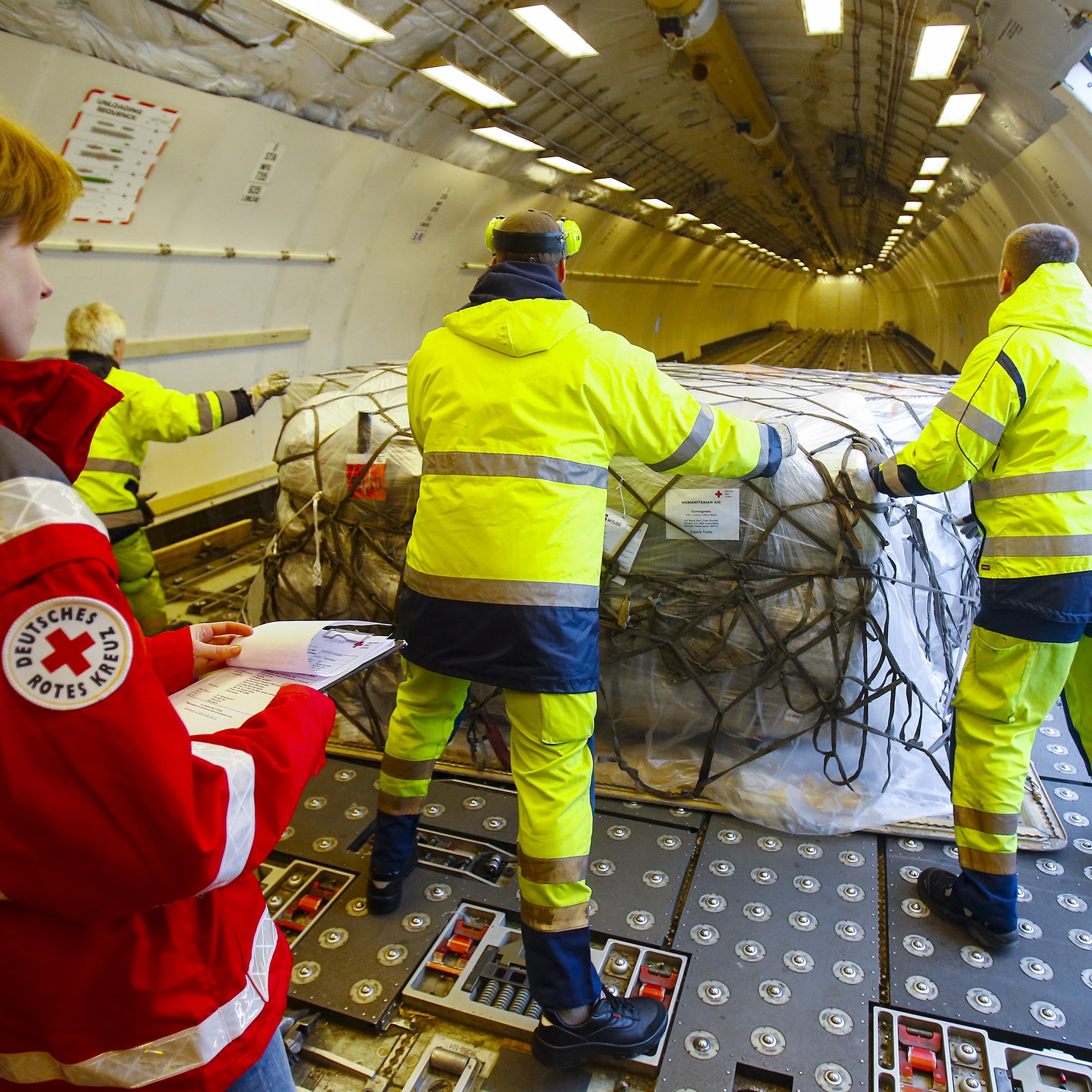 Workers load humanitarian aid from German Red Cross (DRK) for victims of the earthquake in Nepal, into an aircraft at Schoenefeld airport outside Berlin April 27, 2015.