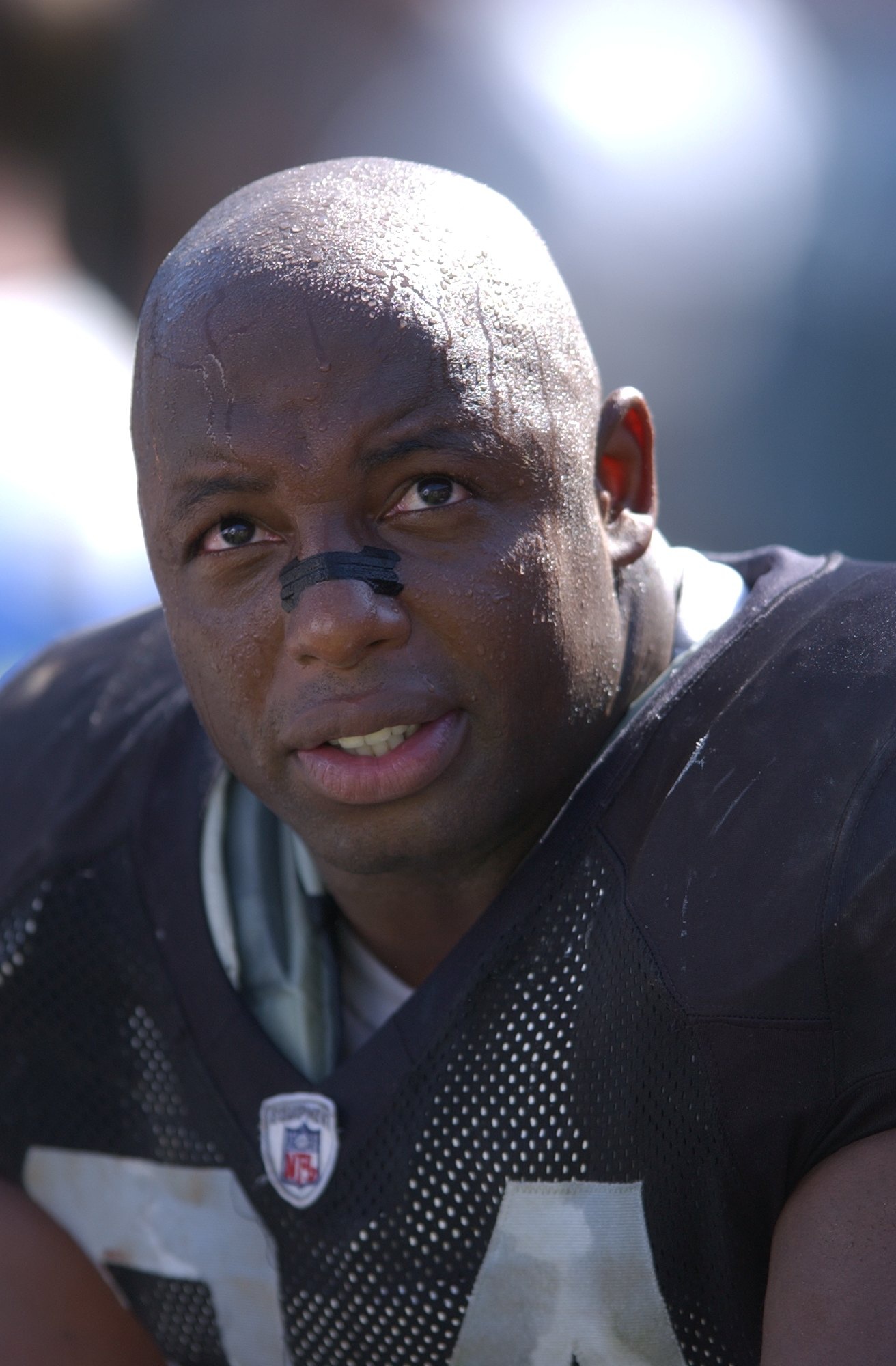 Dana Stubblefield #94 of the Oakland raiders rests on the bench during a game against the Cincinnati Bengals on September 14, 2003 at the Network Associates Coliseum in Oakland, California.
