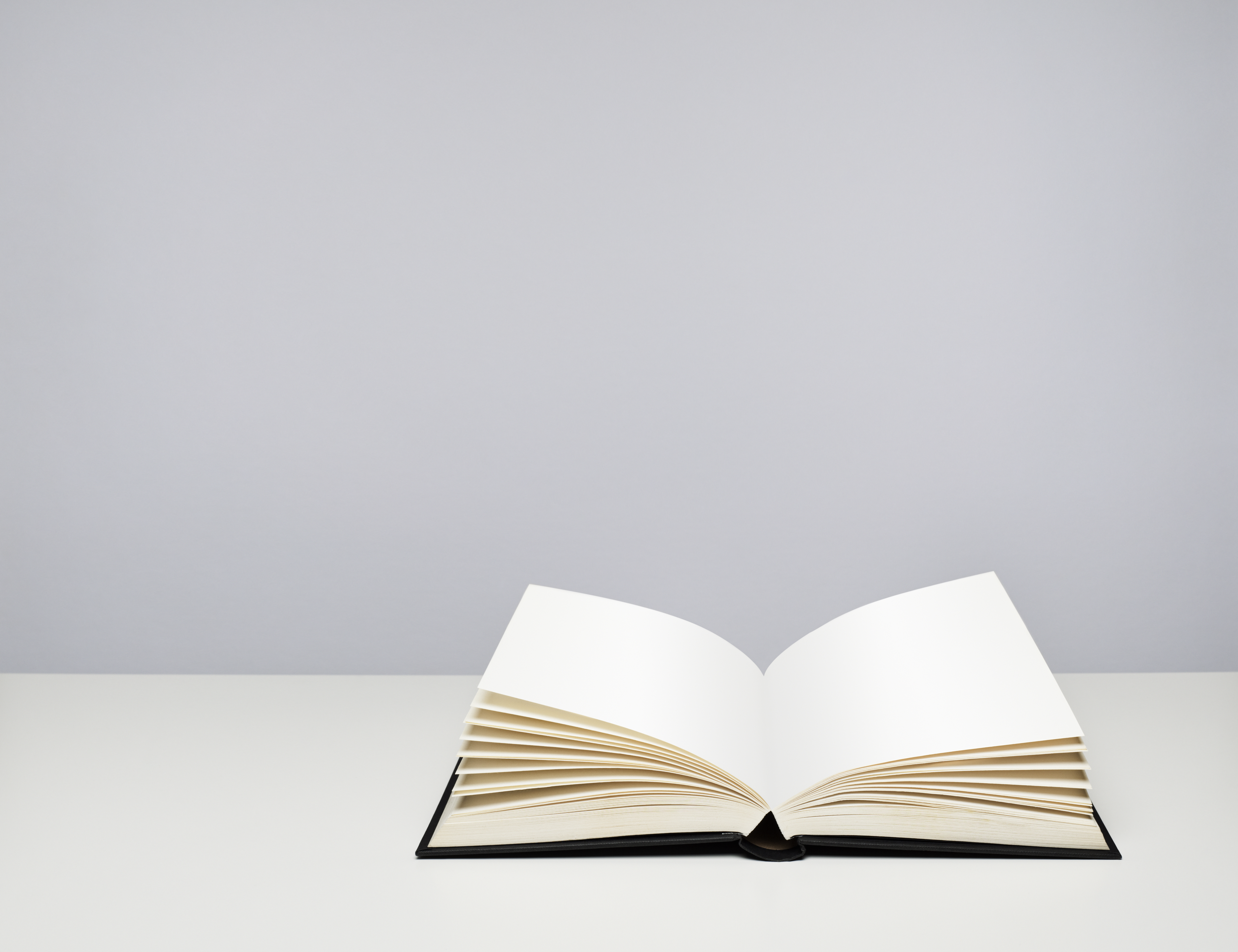 Open blank hardback book on a table