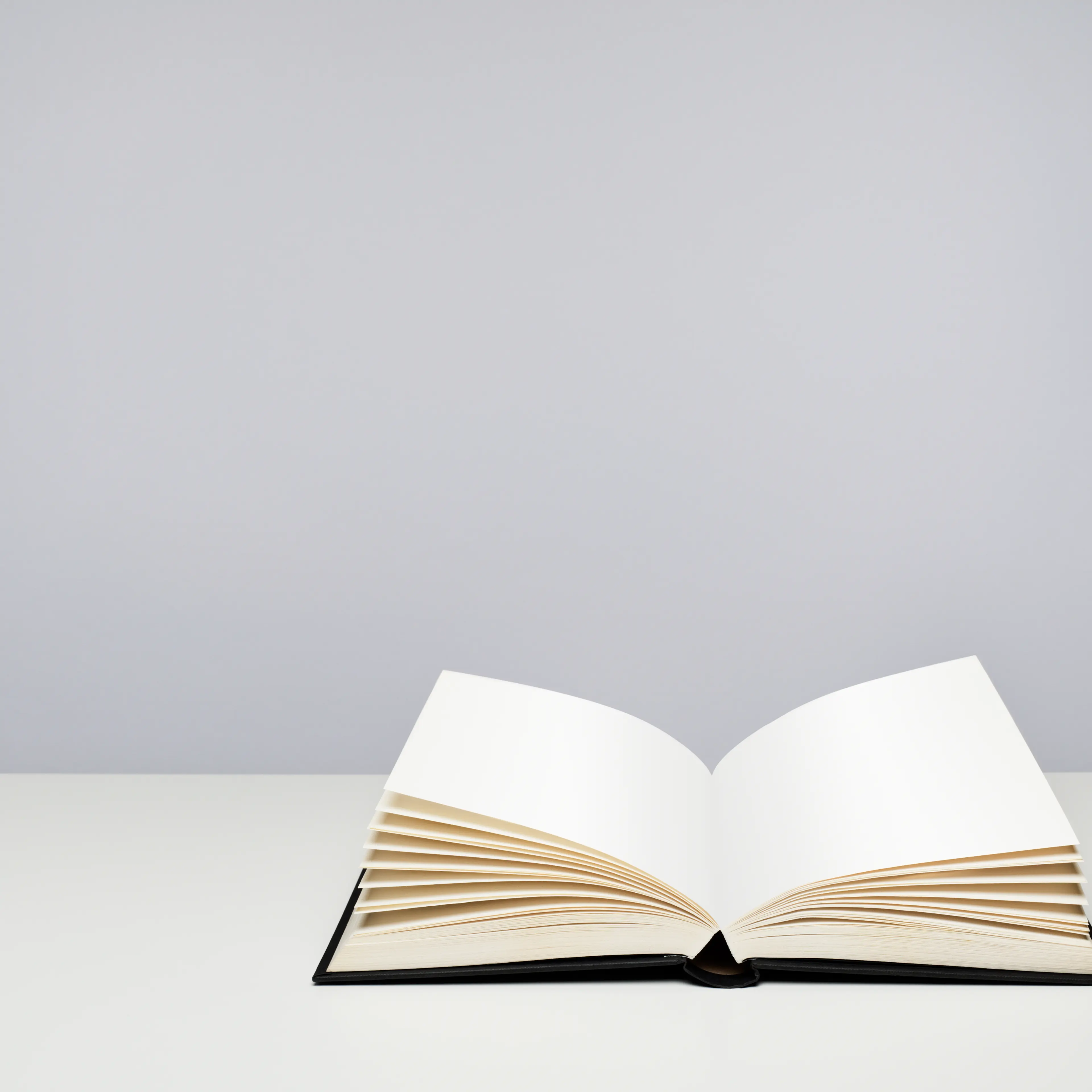 Open blank hardback book on a table