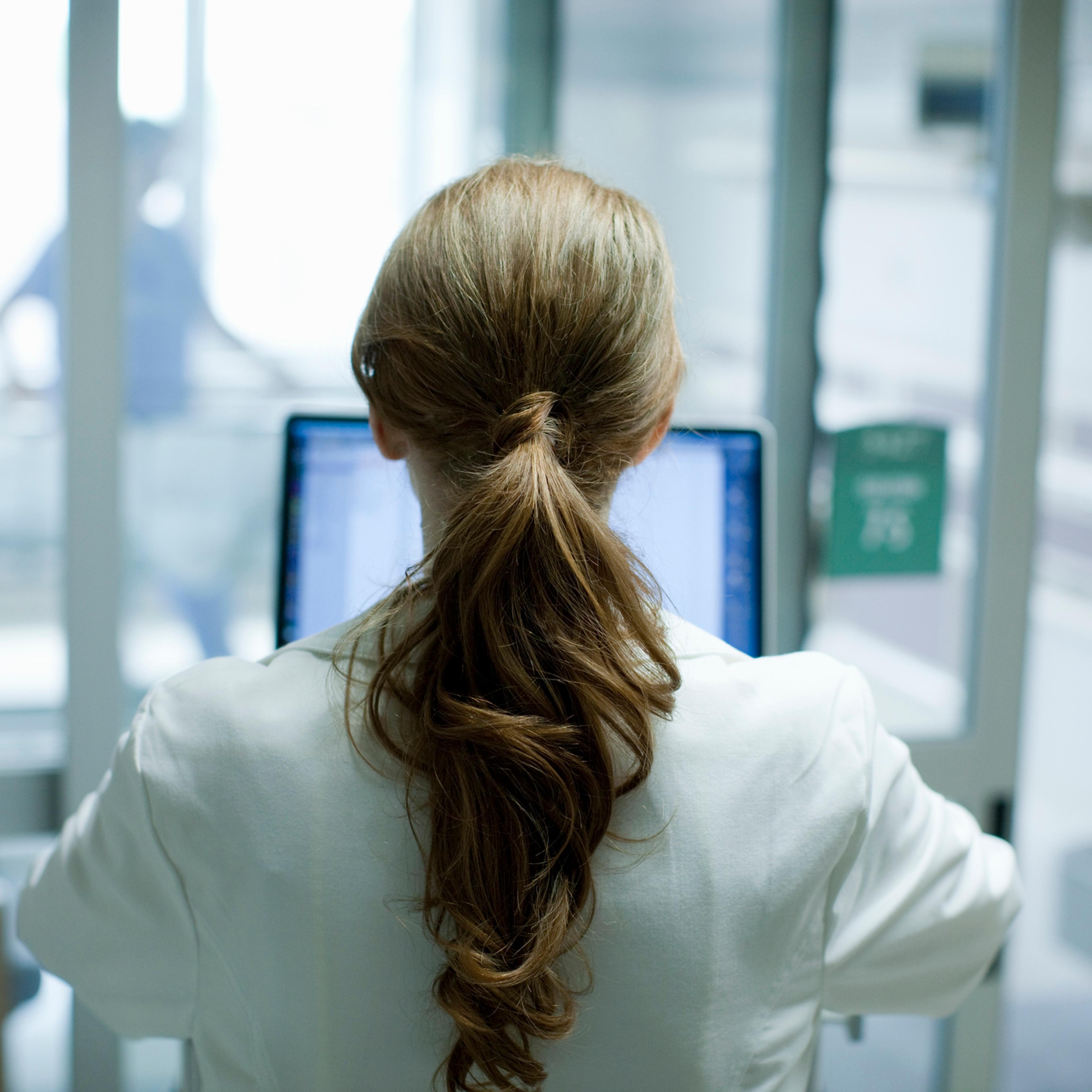 Female doctor using laptop in hospital