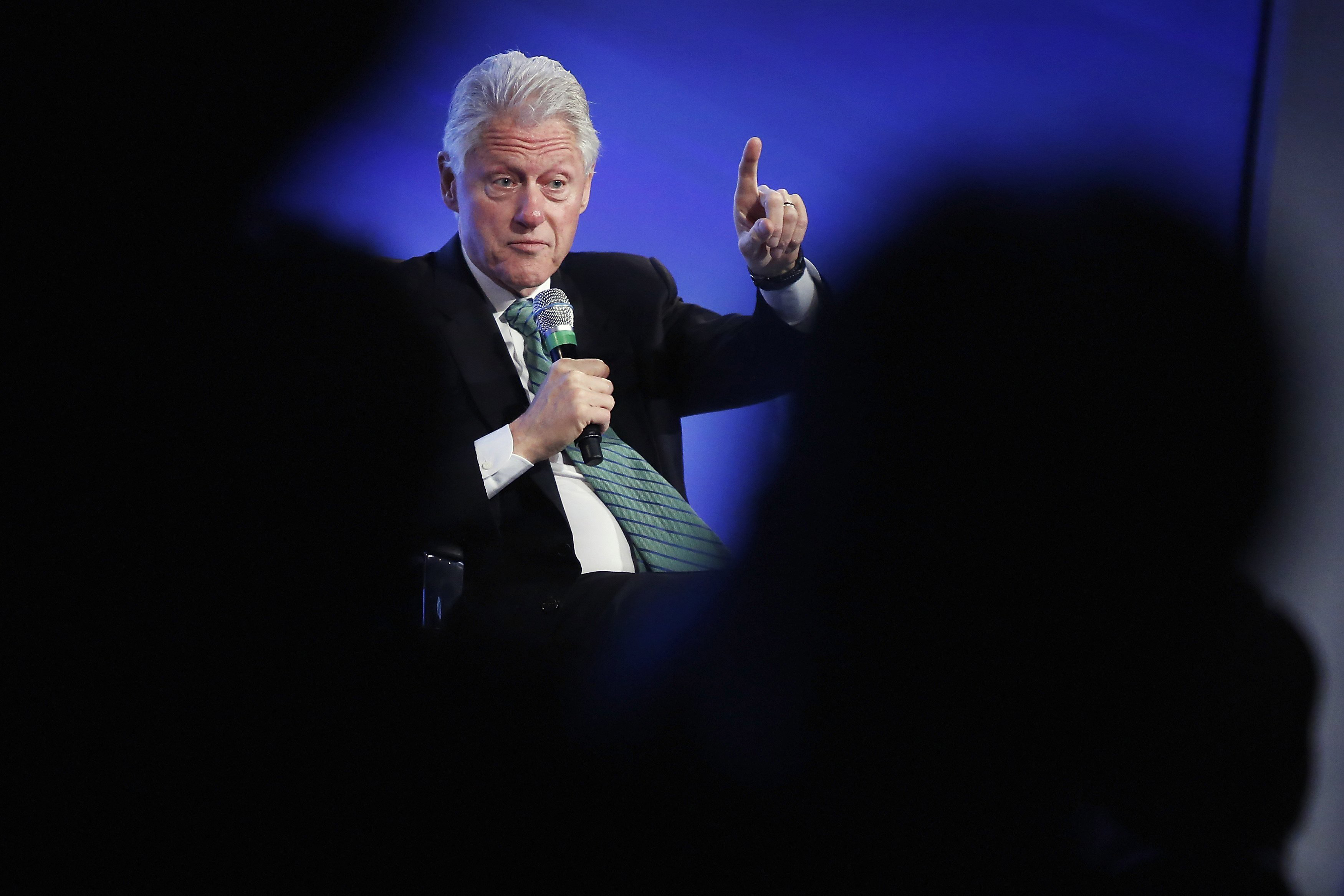 Former President Bill Clinton gestures during an onstage interview at the 2014 Peterson Foundation Fiscal Summit in Washington May 14, 2014.