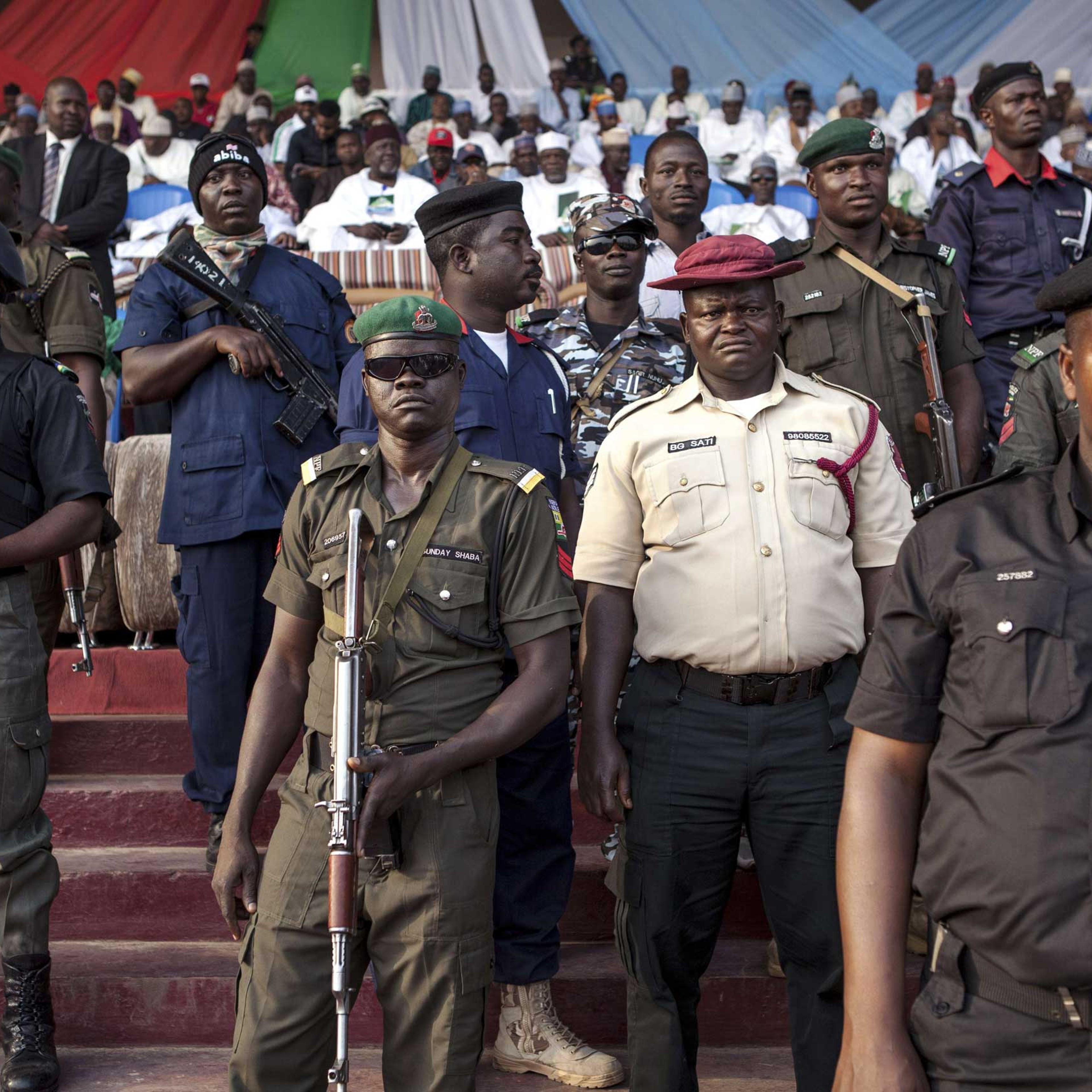 Policemen and soldiers guard during a rally of the main Nigerian opposition All Progressive Congress party in Kaduna, Nigeria on Jan. 19, 2015.