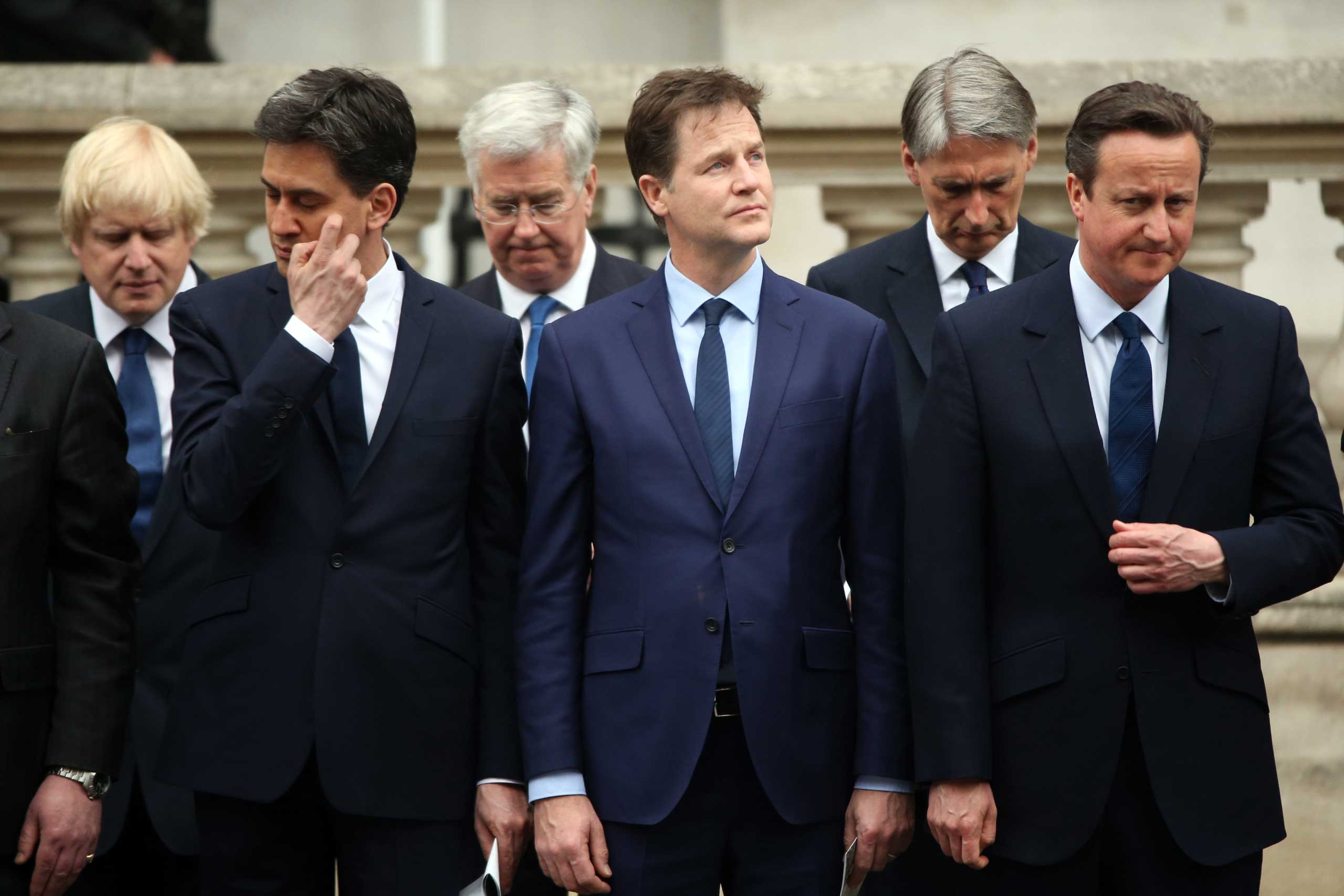 Labour Party leader Ed Miliband, Liberal Democrat leader Nick Clegg and Prime Minister David Cameron stand during a tribute at the Cenotaph to begin three days of national commemorations to mark the 70th anniversary of VE Day on May 8, 2015 in London.