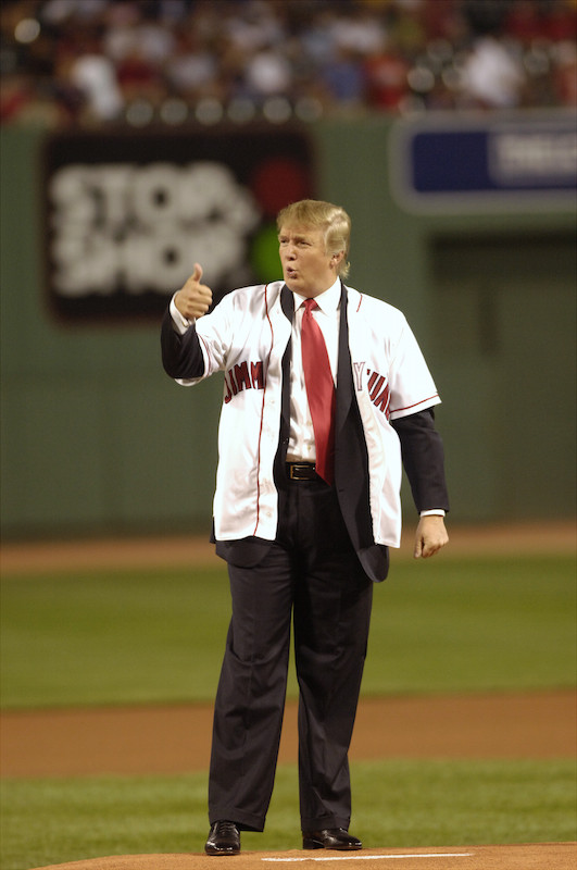 Donald Trump gives a thumbs-up sign after throwing out the c