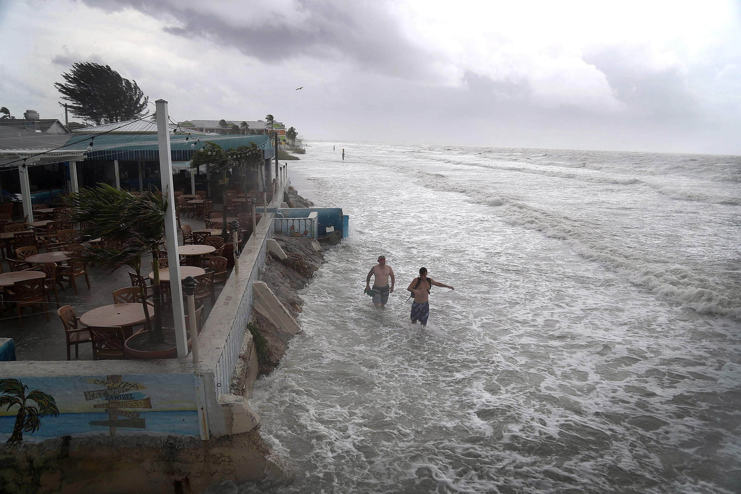 FORT MYERS, FL - JUNE 06: People walk along the beach as waves from Tropical Storm Colin crash along the shore on Fort Myers Beach on June 6, 2016 in Fort Myers, Florida. The Florida Gov. Rick Scott declared a state of emergency with Tropical Storm Colin