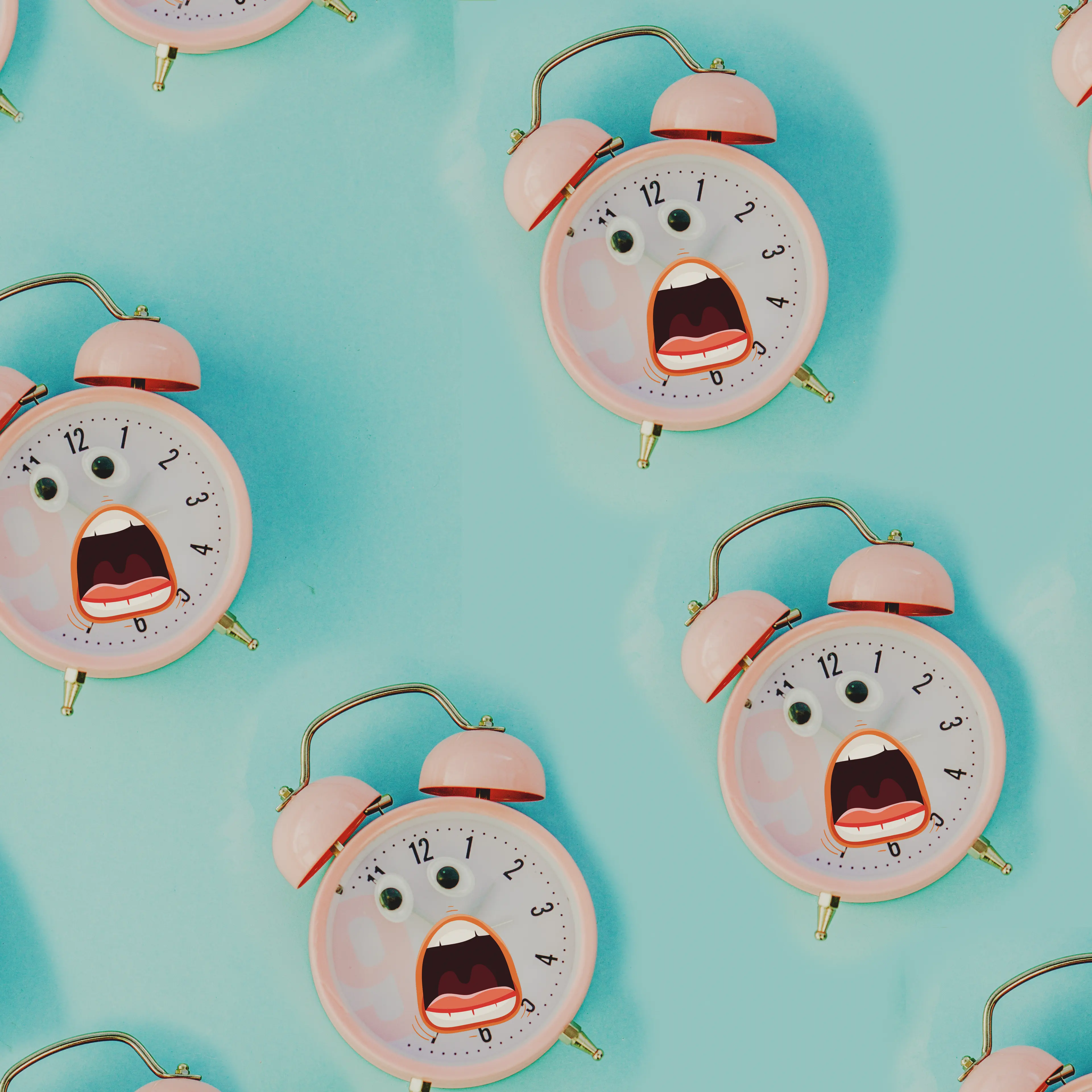 pink alarm clock in pastel colorful background.Top view