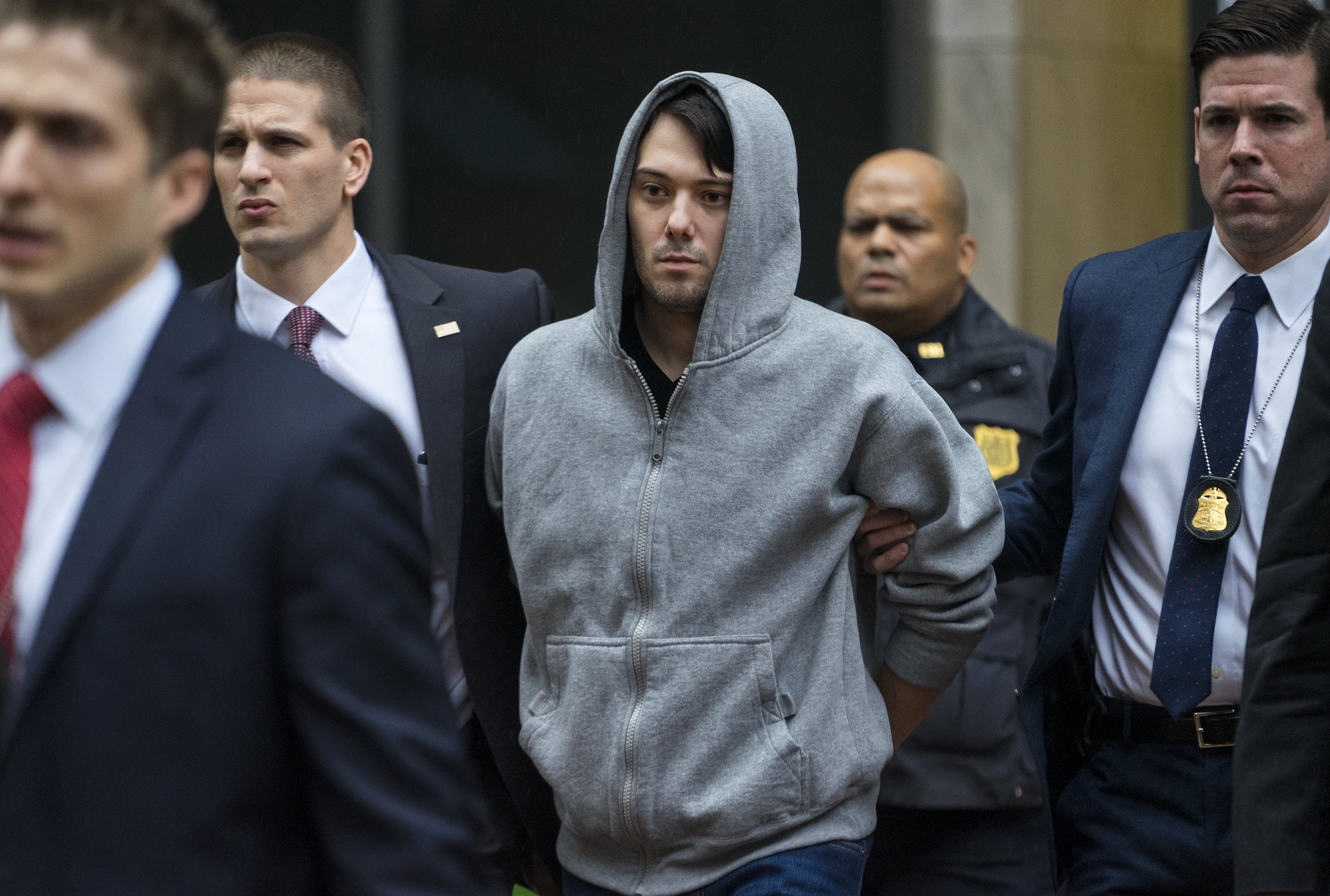Martin Shkreli, the former hedge fund manager under fire for buying a pharmaceutical company and ratcheting up the price of a life-saving drug, is escorted by law enforcement agents in New York on Dec. 17, 2015.