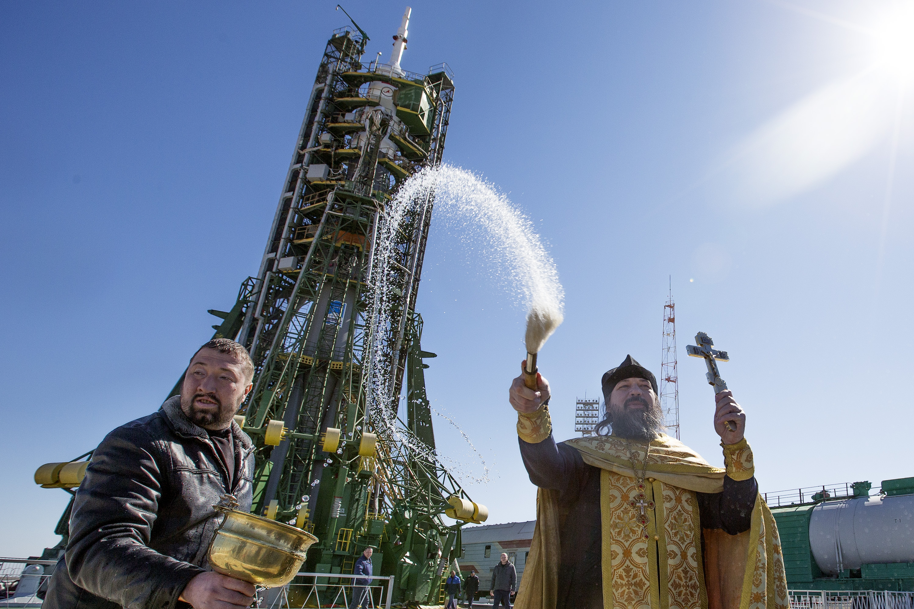 A Russian orthodox priest blesses the Soyuz Rocket, staff and members of the media two days before its launch.  The Rocket will carry American Astronaut Scott Kelly and Russian Cosmonauts Mikhail Kornienko and Gennady Padalka to the International Space S