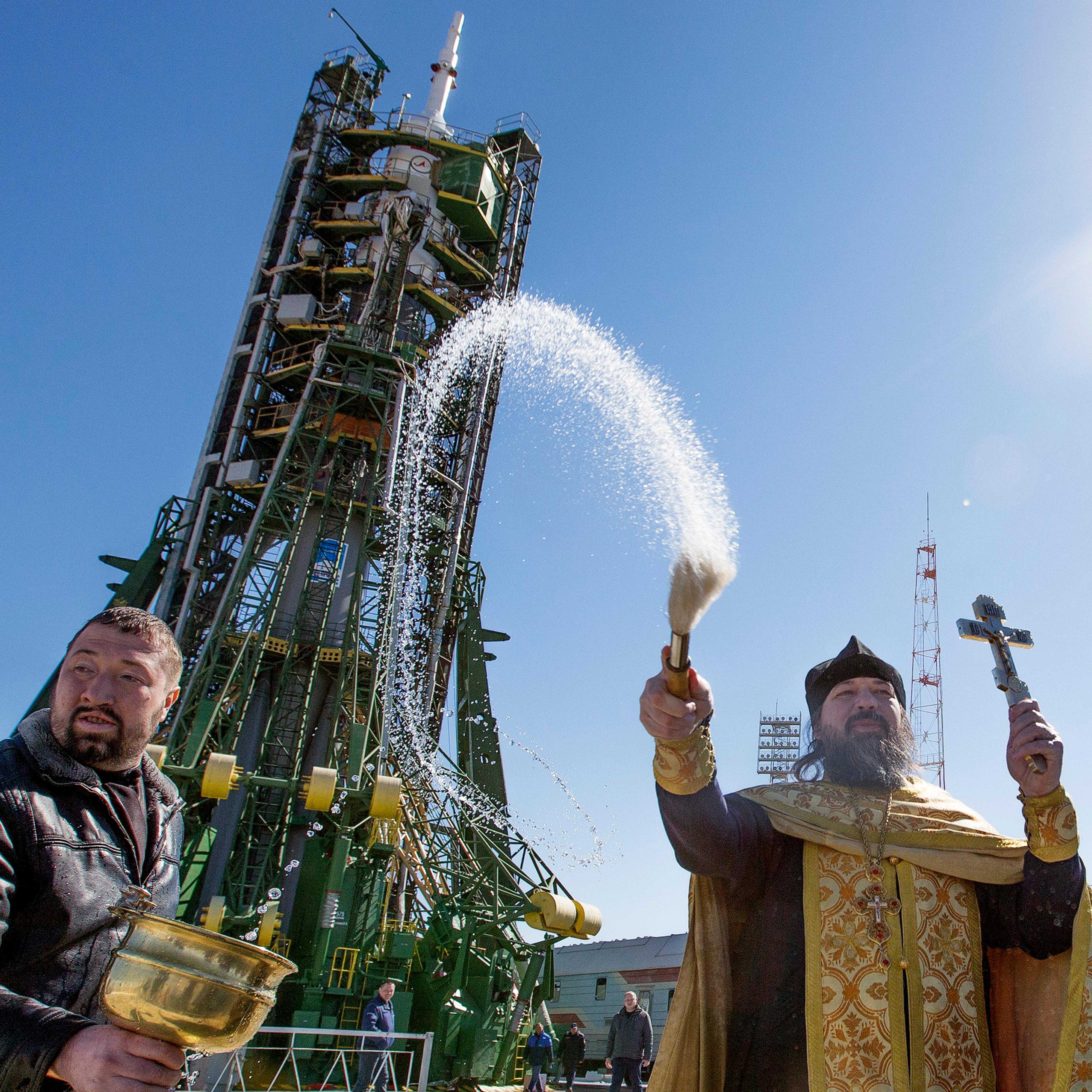 A Russian orthodox priest blesses the Soyuz Rocket, staff and members of the media two days before its launch. The Rocket will carry American Astronaut Scott Kelly and Russian Cosmonauts Mikhail Kornienko and Gennady Padalka to the International Space S