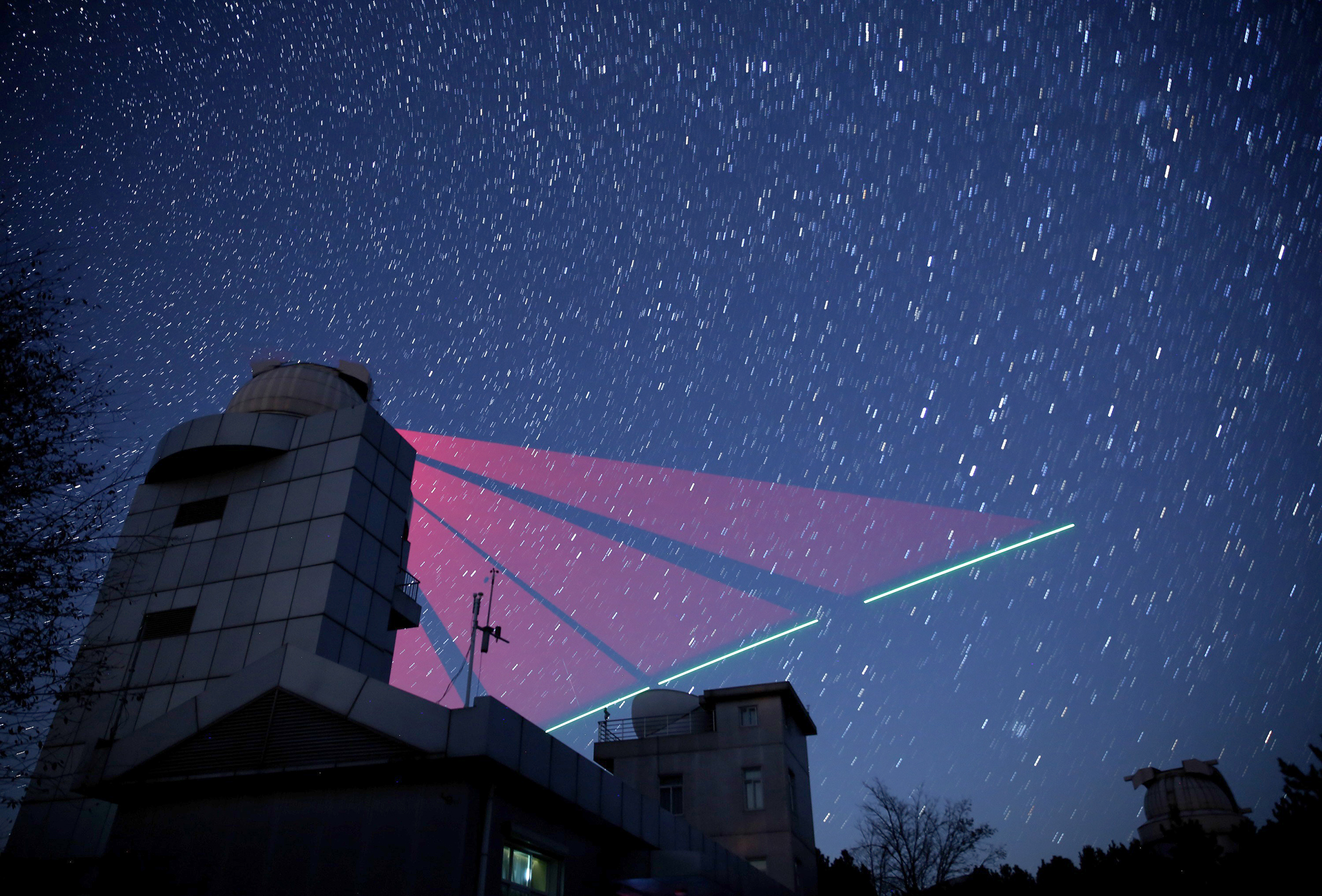 A photo-illustration of a Chinese ground station communicating with the Micius satellite