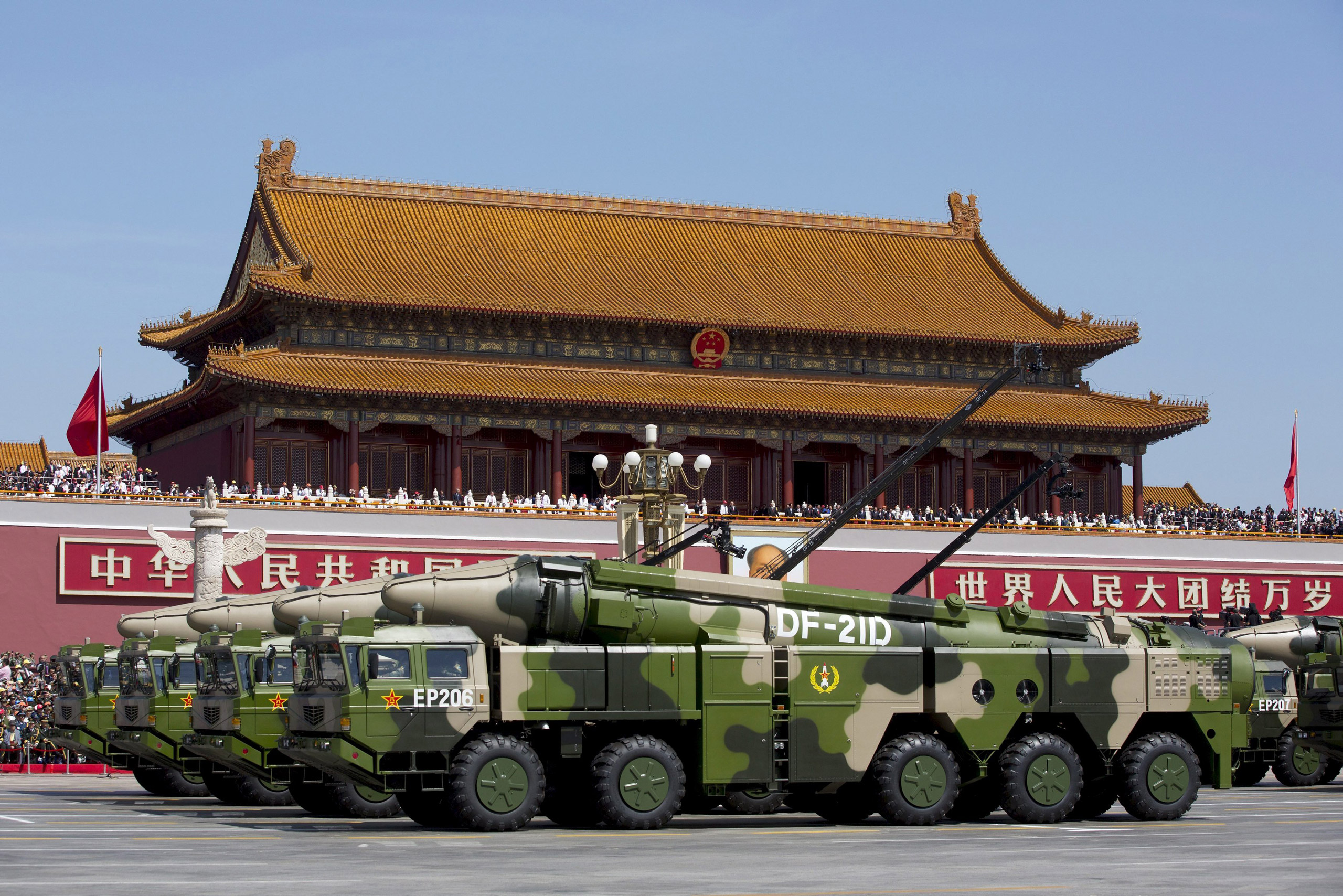 Chinese military vehicles carrying DF-21D anti-ship ballistic missiles, potentially capable of sinking a U.S. Nimitz-class aircraft carrier in a single strike, travel past Tiananmen Gate during a military parade to commemorate the 70th anniversary of the