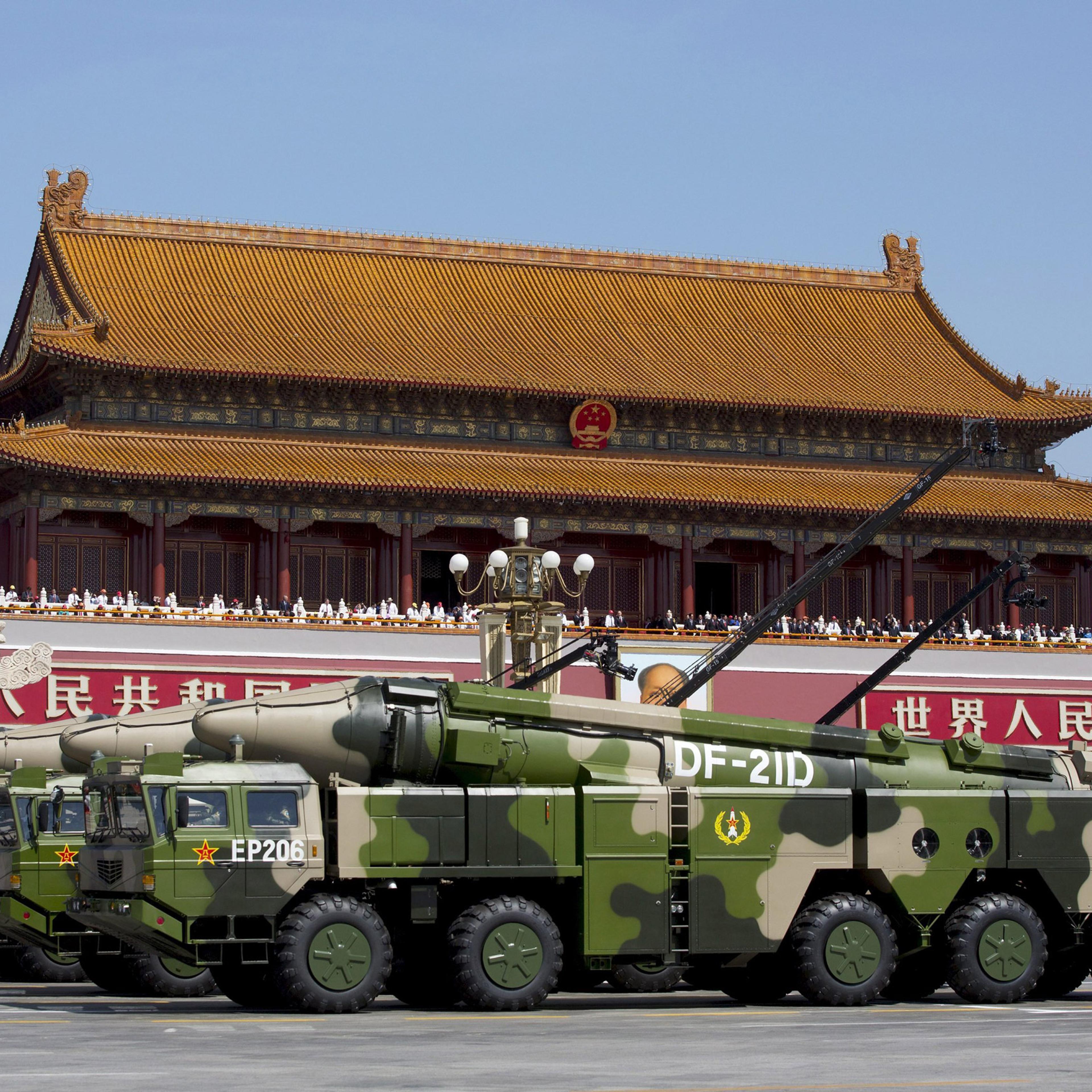 Chinese military vehicles carrying DF-21D anti-ship ballistic missiles, potentially capable of sinking a U.S. Nimitz-class aircraft carrier in a single strike, travel past Tiananmen Gate during a military parade to commemorate the 70th anniversary of the