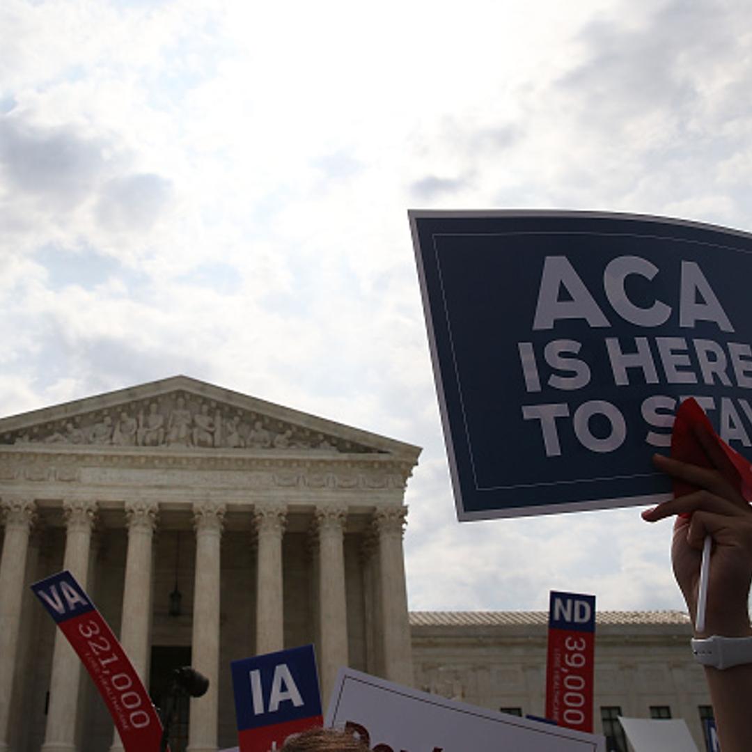 A sign is held up that reads "ACA Is Here To Stay" front of the US Supreme Court after ruling was announced in favor of the Affordable Care Act. June 25, 2015 in Washington, DC.