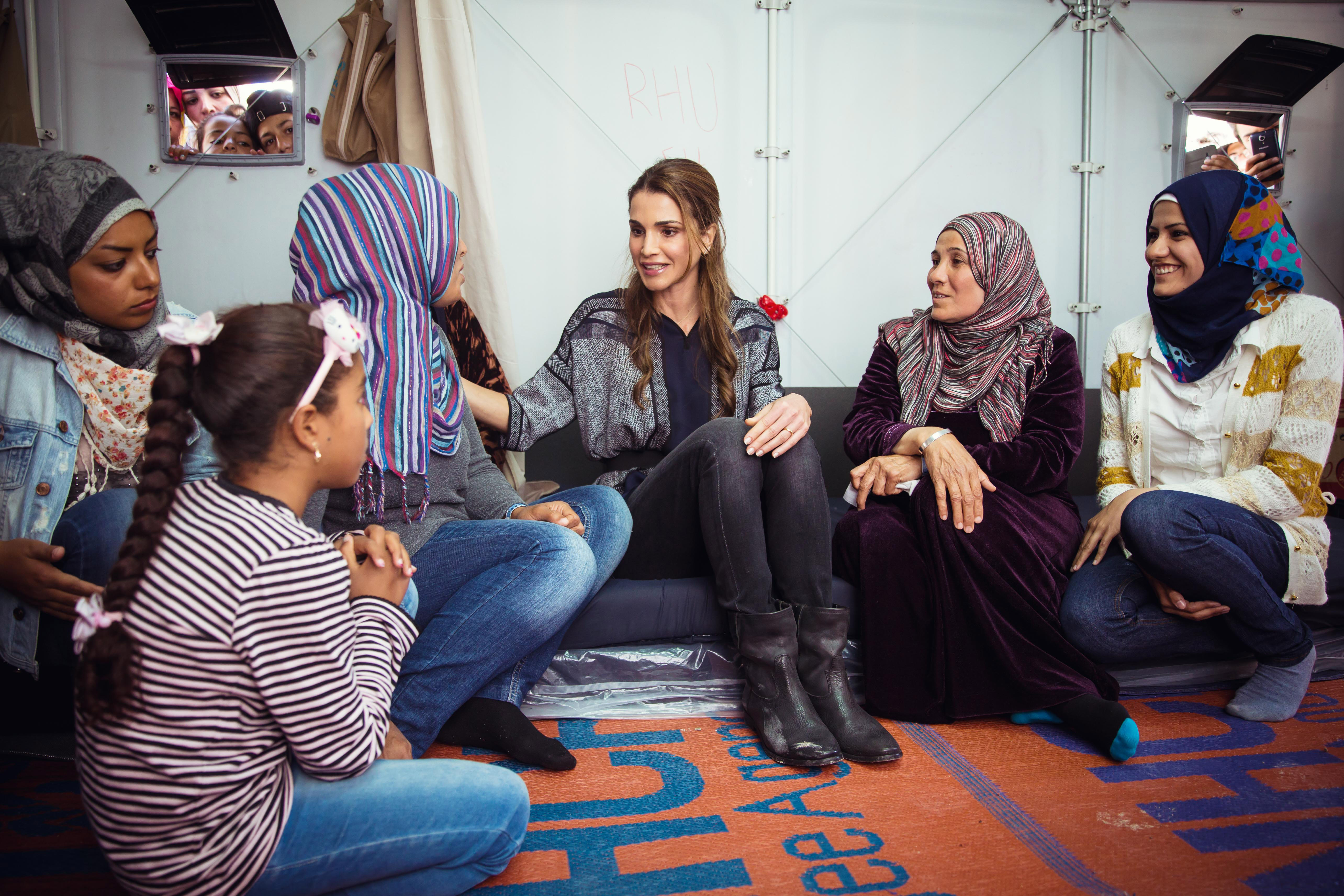 In this handout image supplied by the Office of Her Majesty Queen Rania Al Abdullah, Royal Hashemite Court, Queen Rania of Jordan meets Syrian refuges at the Karatepe municipality camp for refugees on the outskirts of Mytilene in Lesbos, Greece on April 