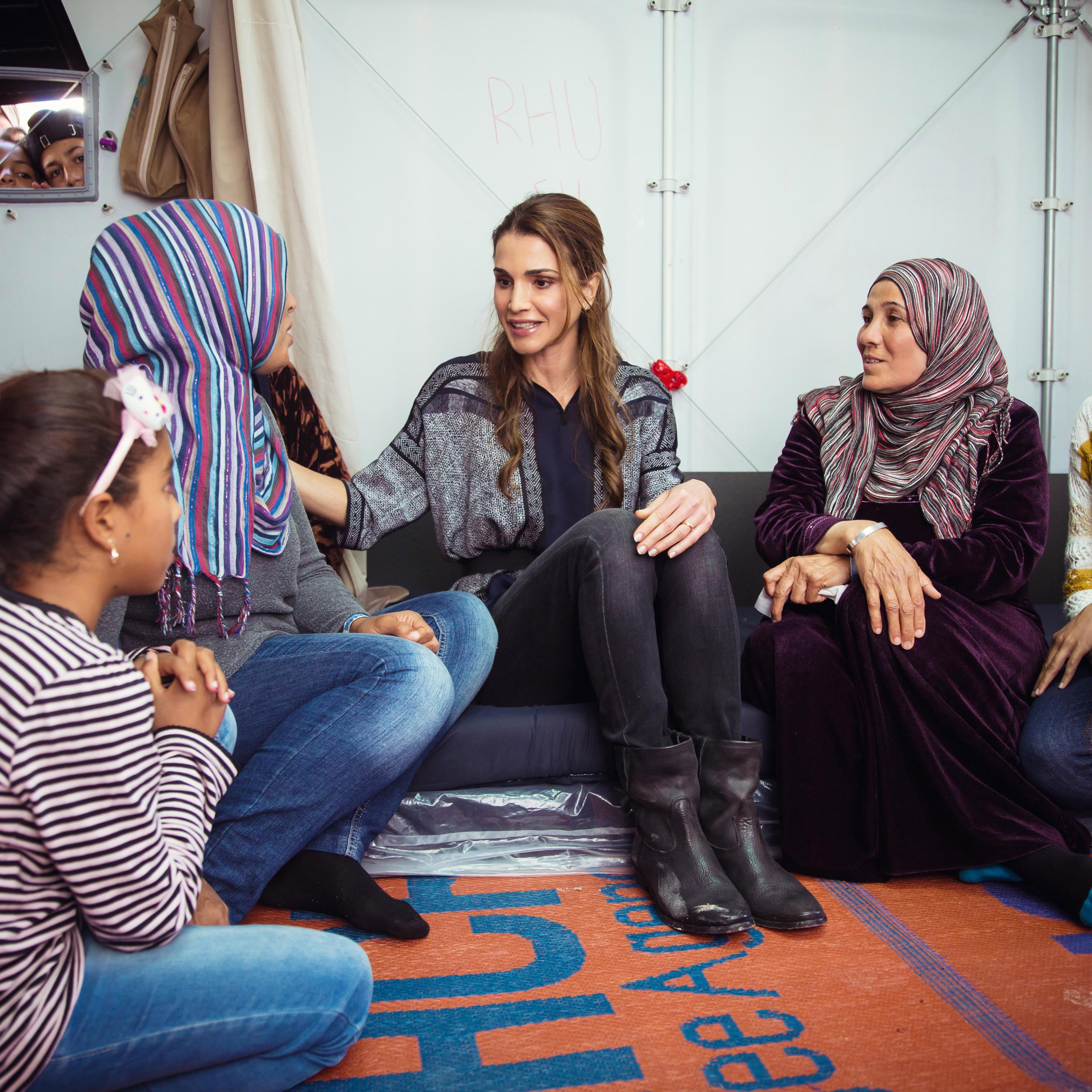 In this handout image supplied by the Office of Her Majesty Queen Rania Al Abdullah, Royal Hashemite Court, Queen Rania of Jordan meets Syrian refuges at the Karatepe municipality camp for refugees on the outskirts of Mytilene in Lesbos, Greece on April