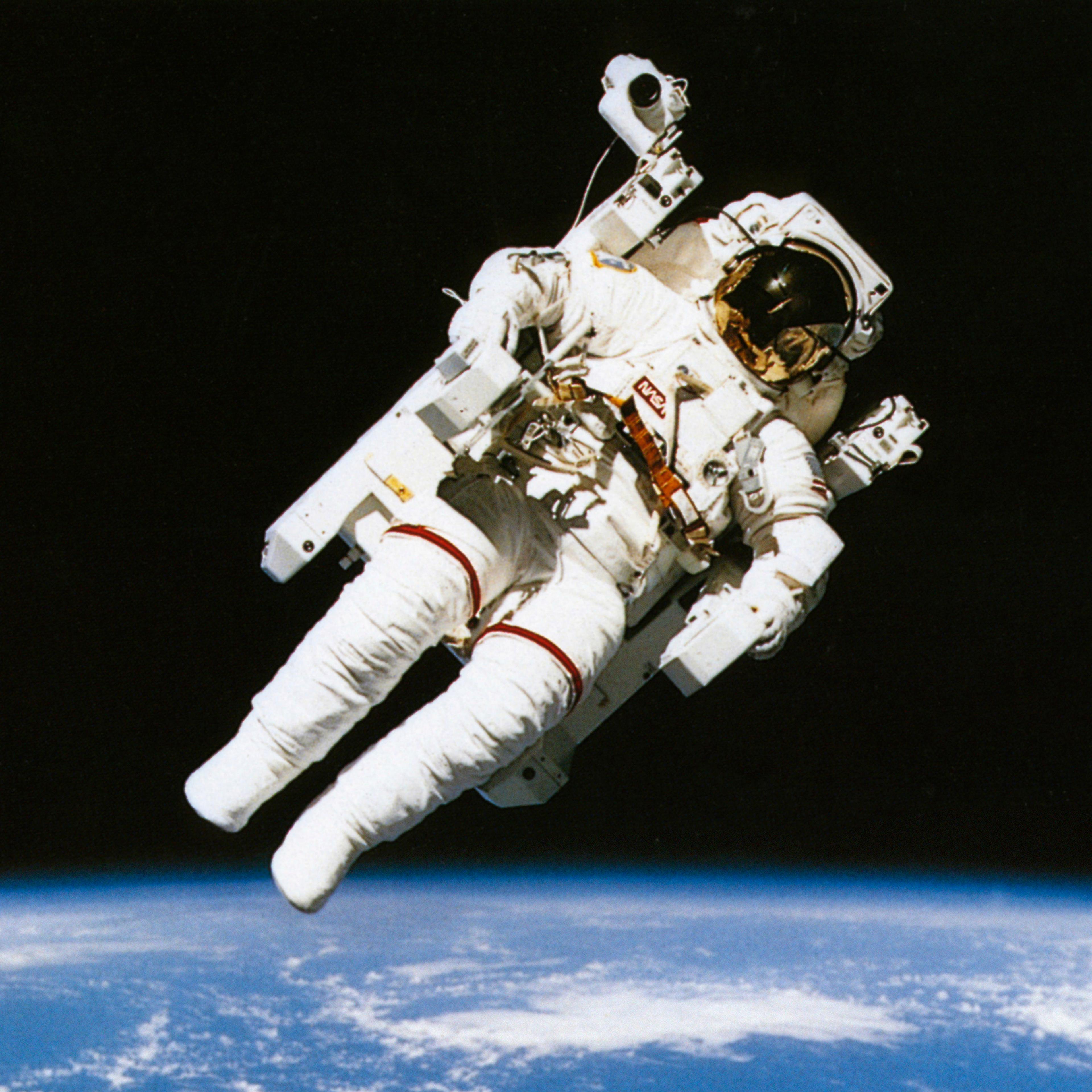 Astronaut floating in orbit above the earth during spacewalk