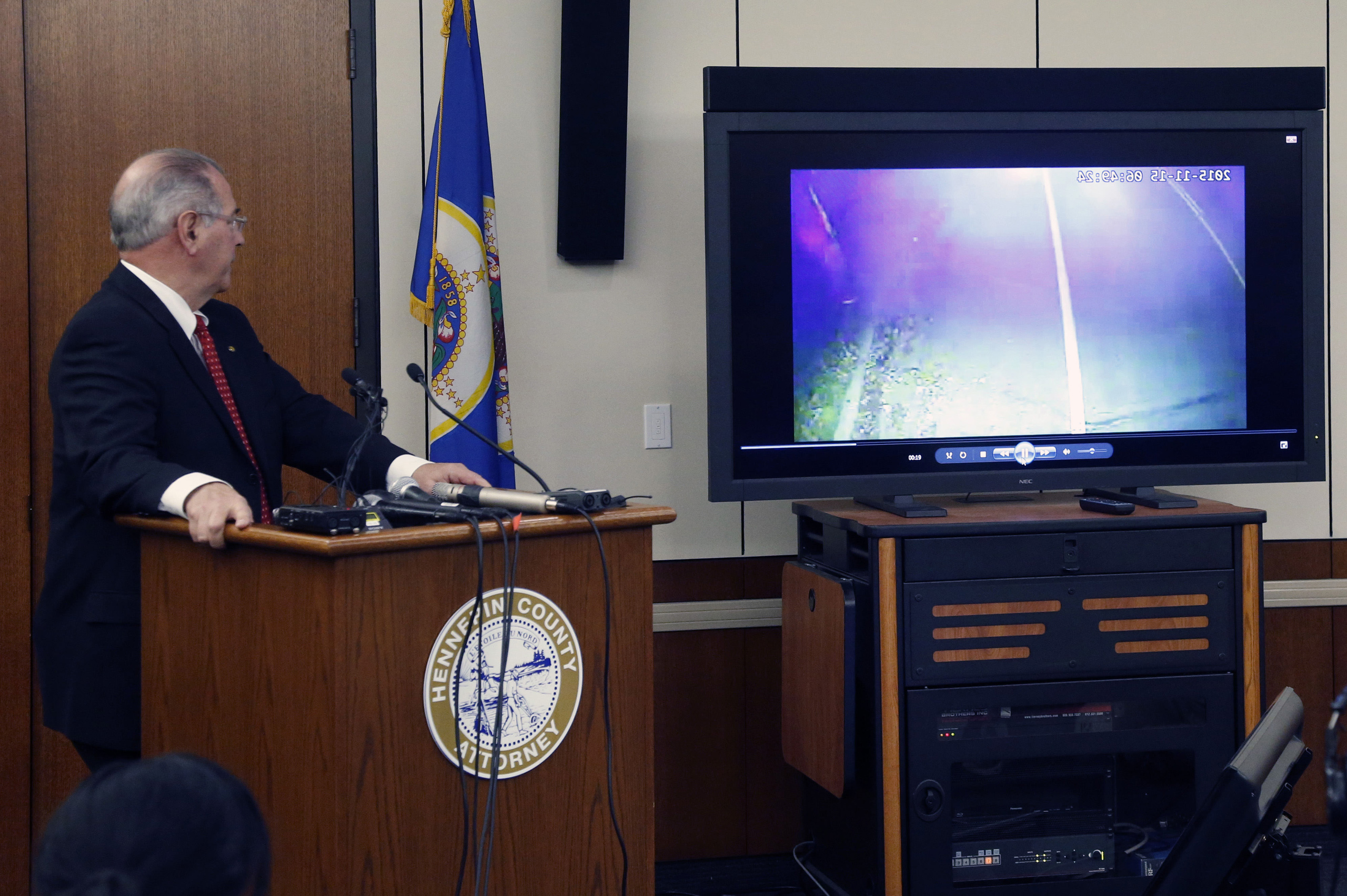 County Attorney Mike Freeman, shows video from evidence after he announced in Minneapolis on March 30, 2016.