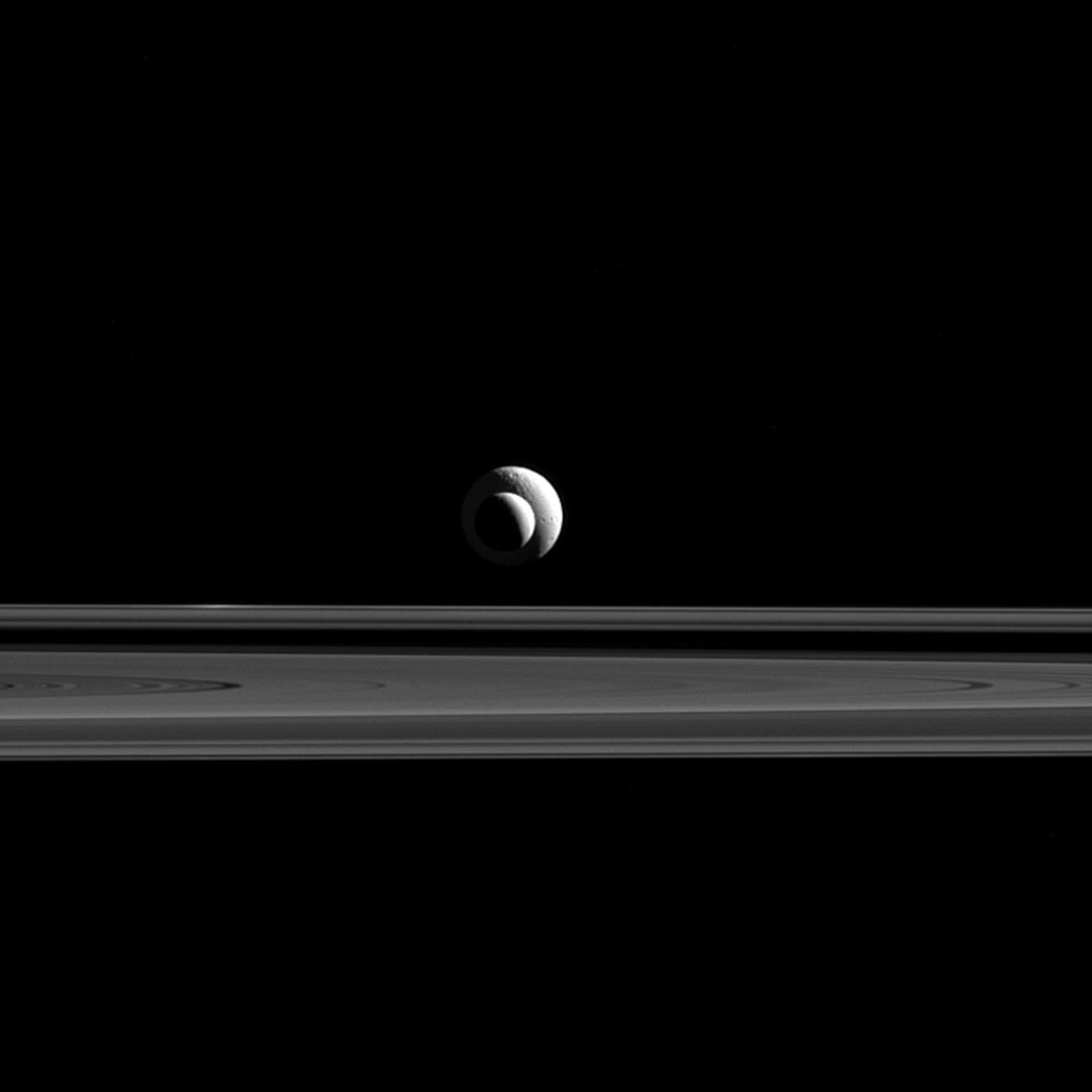 Like a cosmic bull's-eye, Enceladus and Tethys line up almost perfectly for Cassini's cameras. The image was taken in red light with the Cassini spacecraft narrow-angle camera on Sept. 24, 2015.
