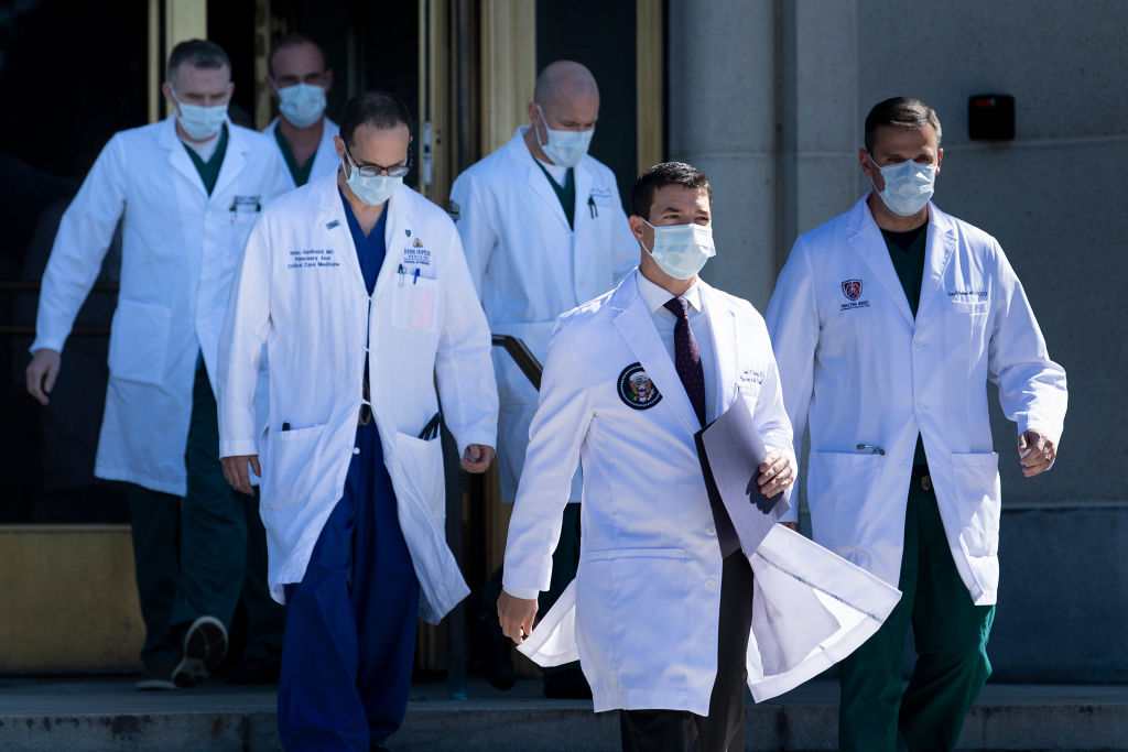 White House physician Sean Conley (2nd R), with medical staff, arrives to give an update on the condition of US President Donald Trump.