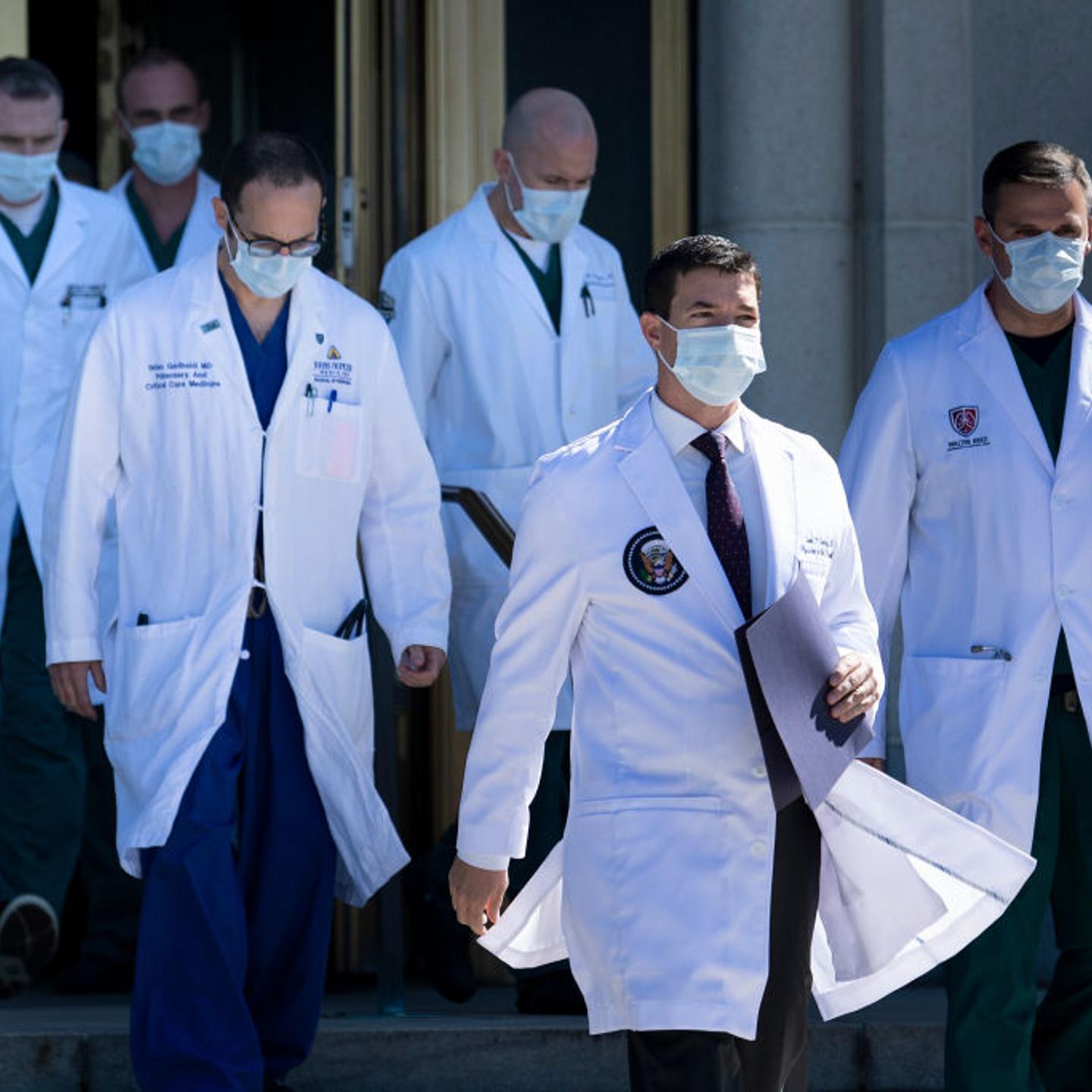 White House physician Sean Conley (2nd R), with medical staff, arrives to give an update on the condition of US President Donald Trump.