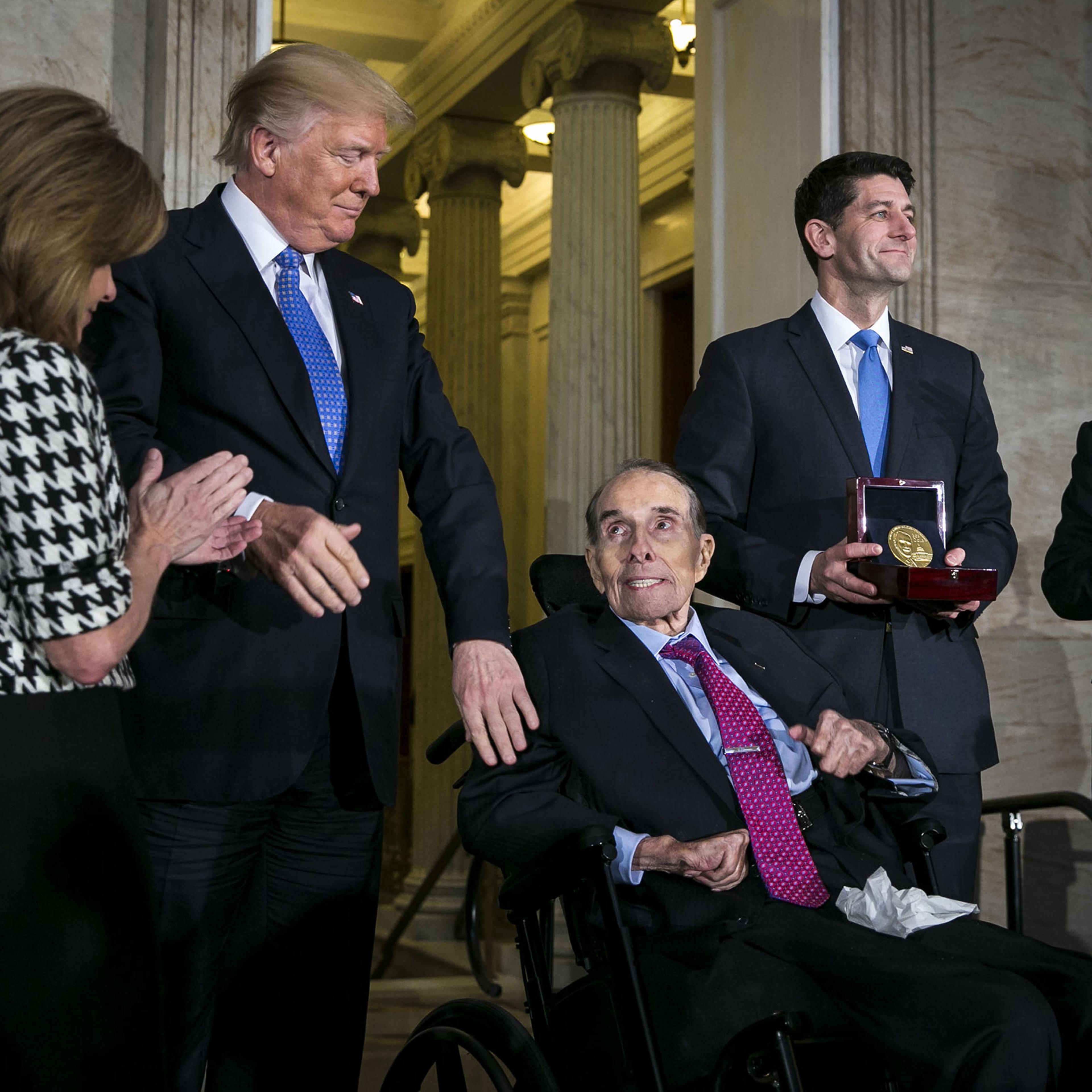 President Donald Trump greets former Senate Majority Leader Bob Dole as House Speaker Paul Ryan holds a Congressional Gold Medal during a ceremony at the Capitol, in Washington on Jan. 17, 2018.