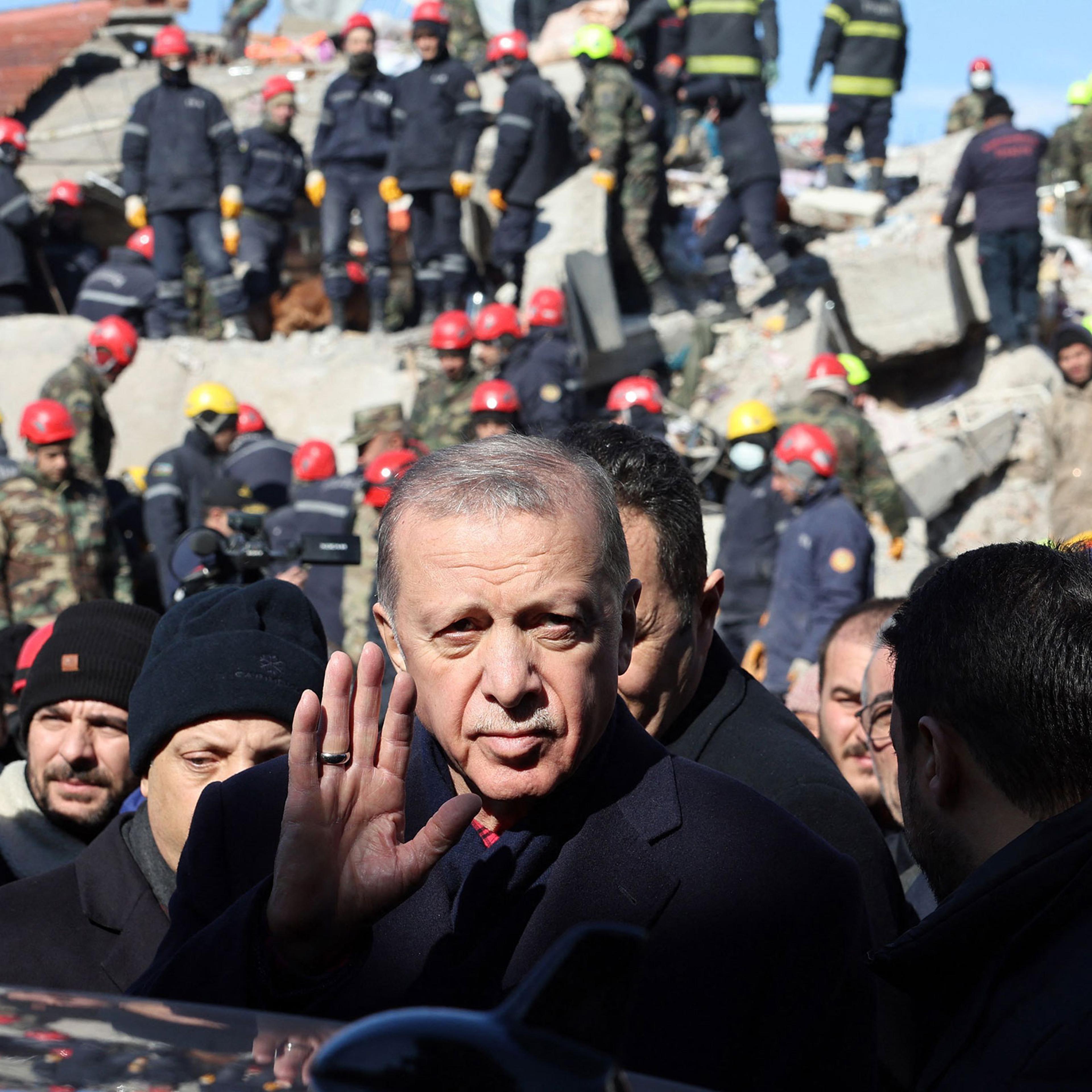 Turkish President Recep Tayyip Erdogan tours the site of destroyed buildings during his visit to the city of Kahramanmaras in southeast Turkey, two days after the severe earthquake that hit the region on Feb. 8, 2023.