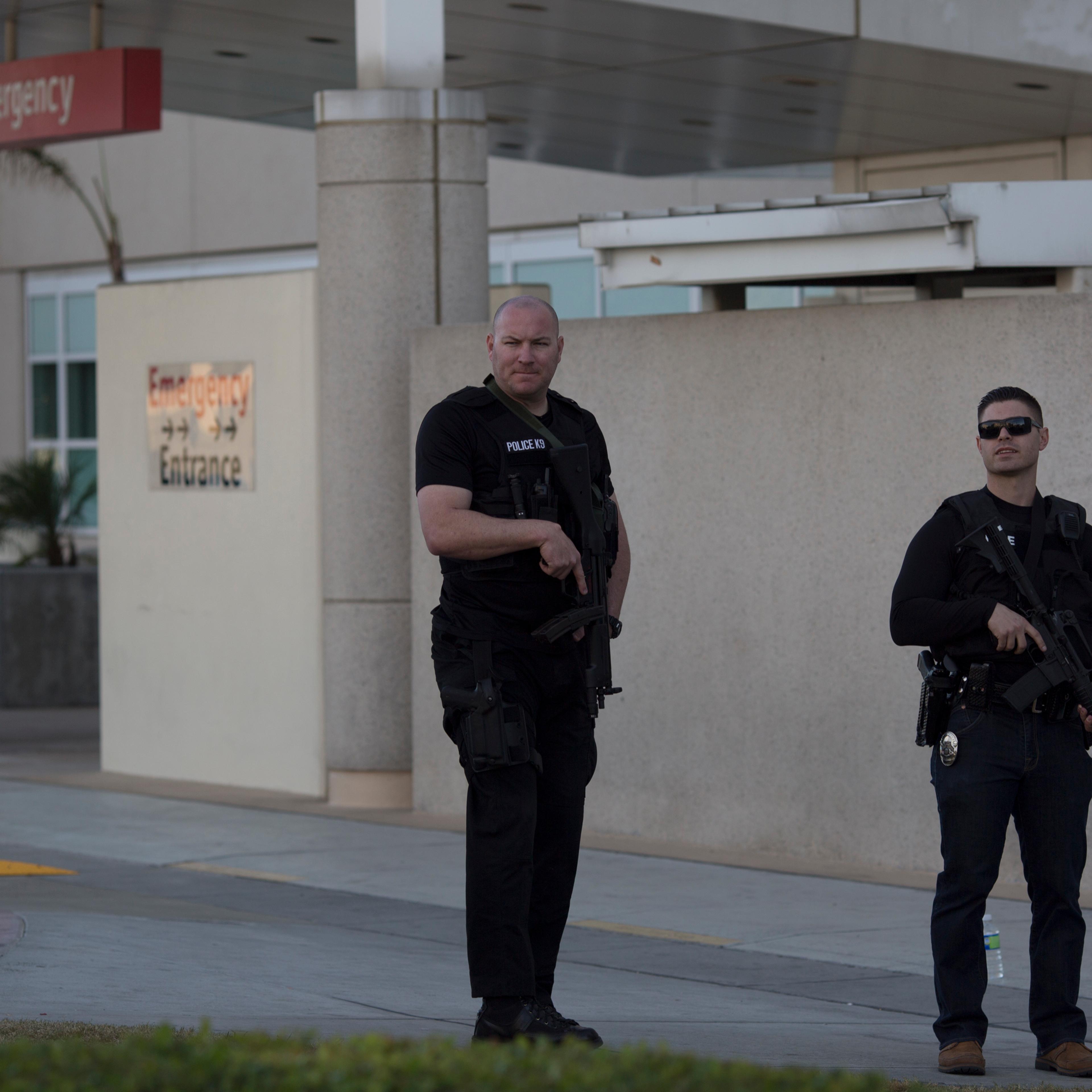 Police officers guard the emergency entrance at Arrowhead Regional Medical Center where numerous victims of a mass shooting at the Inland Regional Center were admitted on December 2, 2015 in San Bernardino, California.