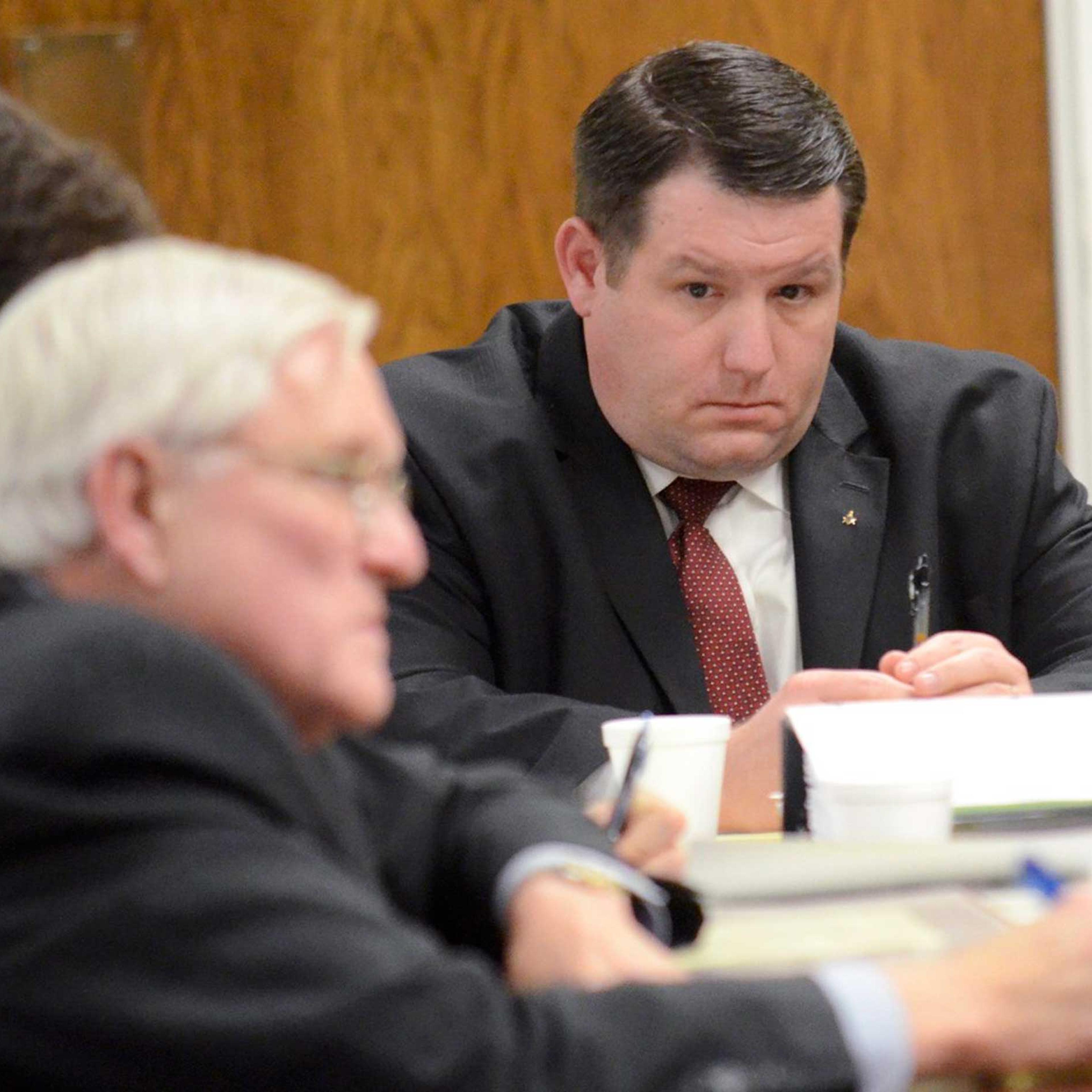 Former Eutawville Police Chief Richard Combs sits with lawyers on the second day of testimony in his trial for the murder of Bernard Bailey in Orangeburg, South Carolina, Jan. 8, 2015.