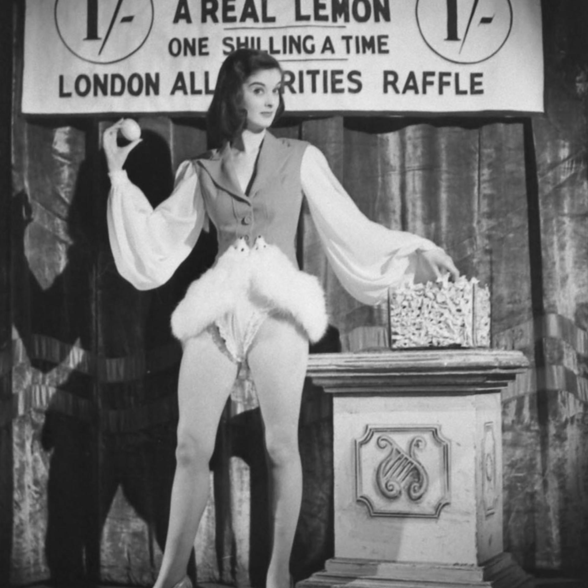 In the midst of a wartime lemon shortage, a woman "auctions off" a lemon in London, 1944. (The auction was staged by photographer David Scherman.)