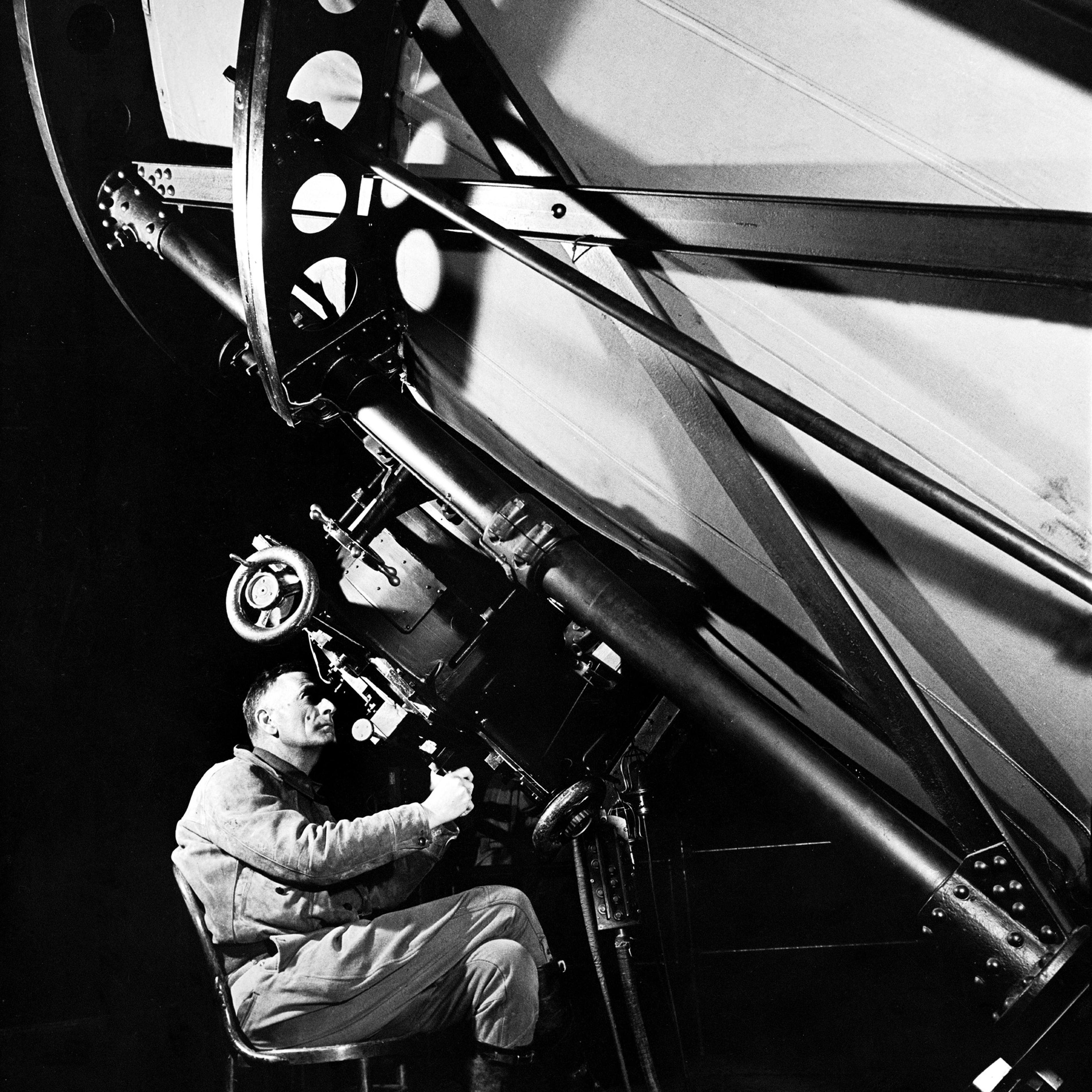 Astronomer Edwin Hubble looks though the eyepiece of the 100-inch telescope at California's Mt. Wilson Observatory, 1937.