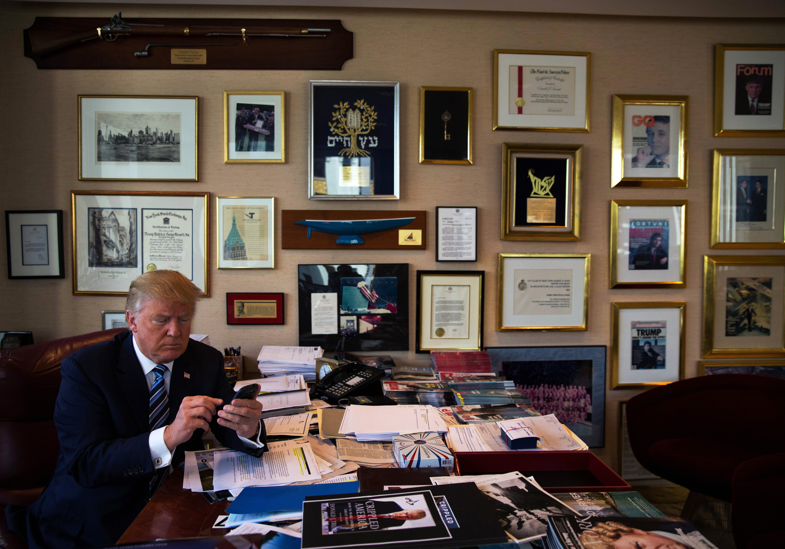 Donald Trump demonstrates how he Tweets using his Samsung phone in his office in the Trump Tower in New York City on Sept. 29, 2015.
